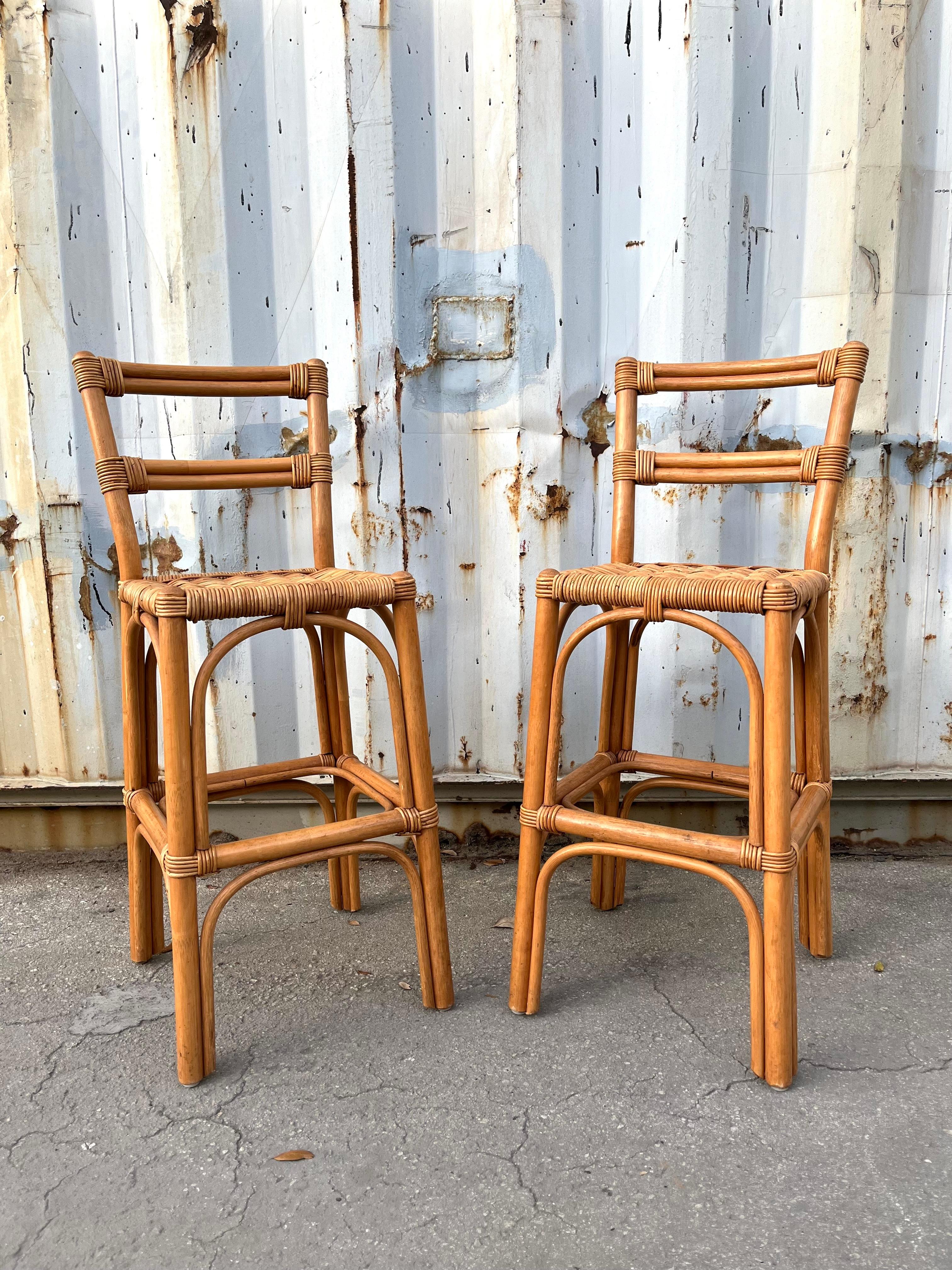 A Pair of Vintage Bohemian / Coastal Style Rattan Bar Stools. Circa 1970s
Feature sculpted rattan frames with woven seats.
In excellent near mint original condition with very minor signs of wear and age. Please see close up pictures for more