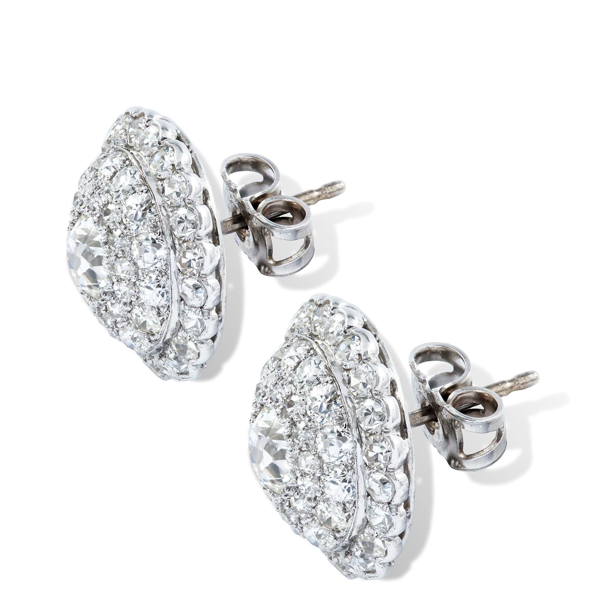 A pair of bombe diamond-set earrings, the old brilliant-cut diamonds estimated to weigh 1 carat in total for the pair set to the centre of domed circle encrusted throughout with eight and old brilliant-cut diamonds, within a scalloped border of