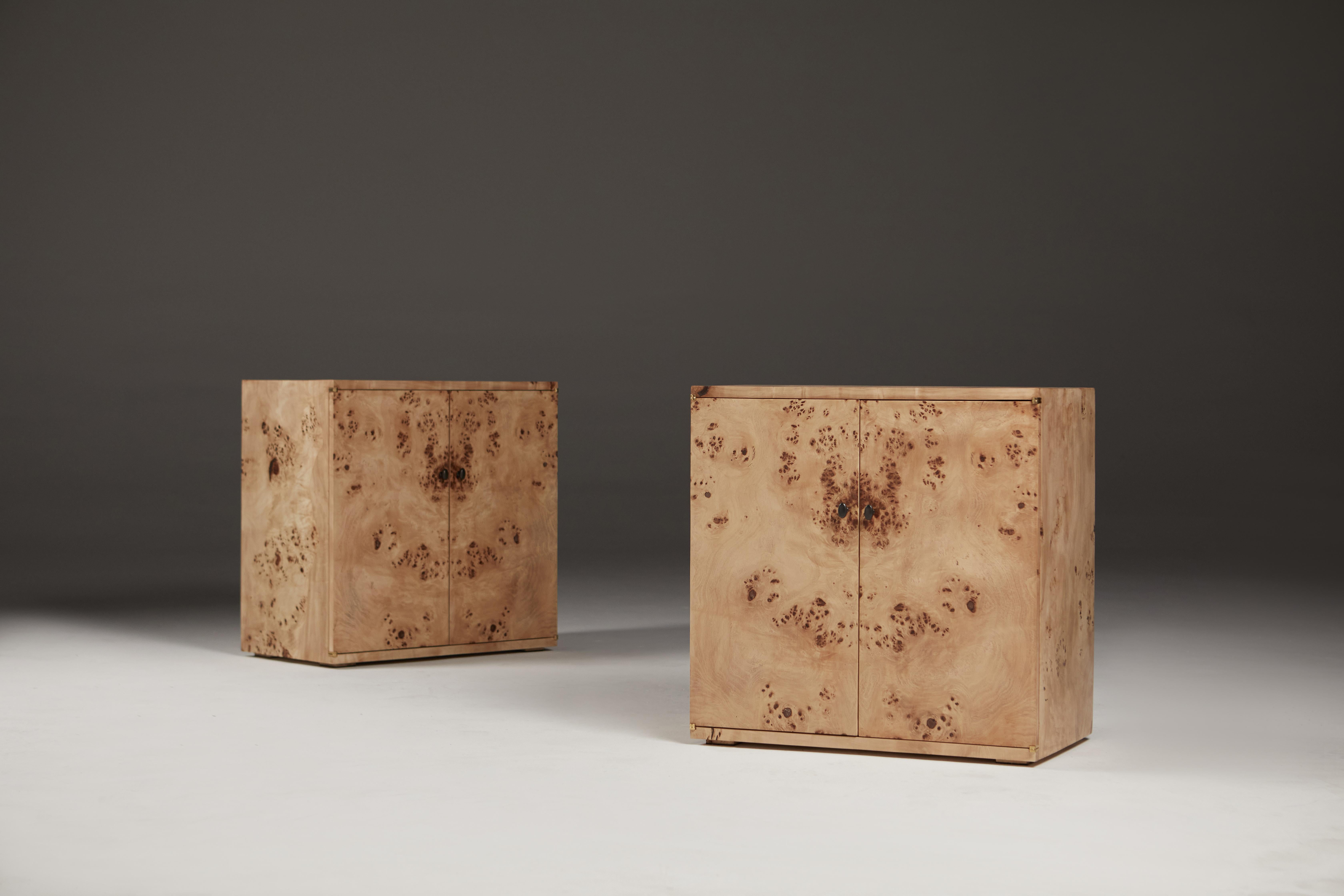 Book-matched bedside or living room cabinets in Mappa Burr.
A pair of bedside cabinets in Mappa Burr (Poplar) with bronze handles. 
Internally there is a single adjustable shelf. The doors are held closed by earth magnets and have traditional bronze