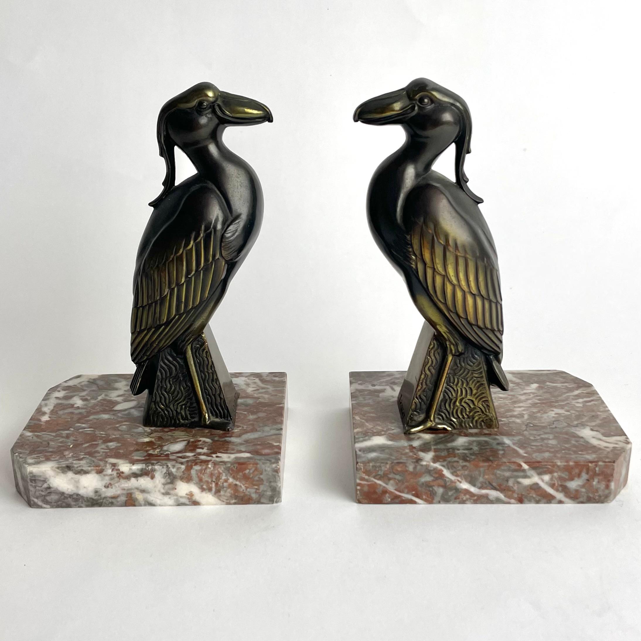 A pair of Bookends with birds signed Jamar in period Art Deco from the 1930s. Made in France by Jamar in patinated metal with a marble base. Period and beautiful birds.

Wear consistent with age and use