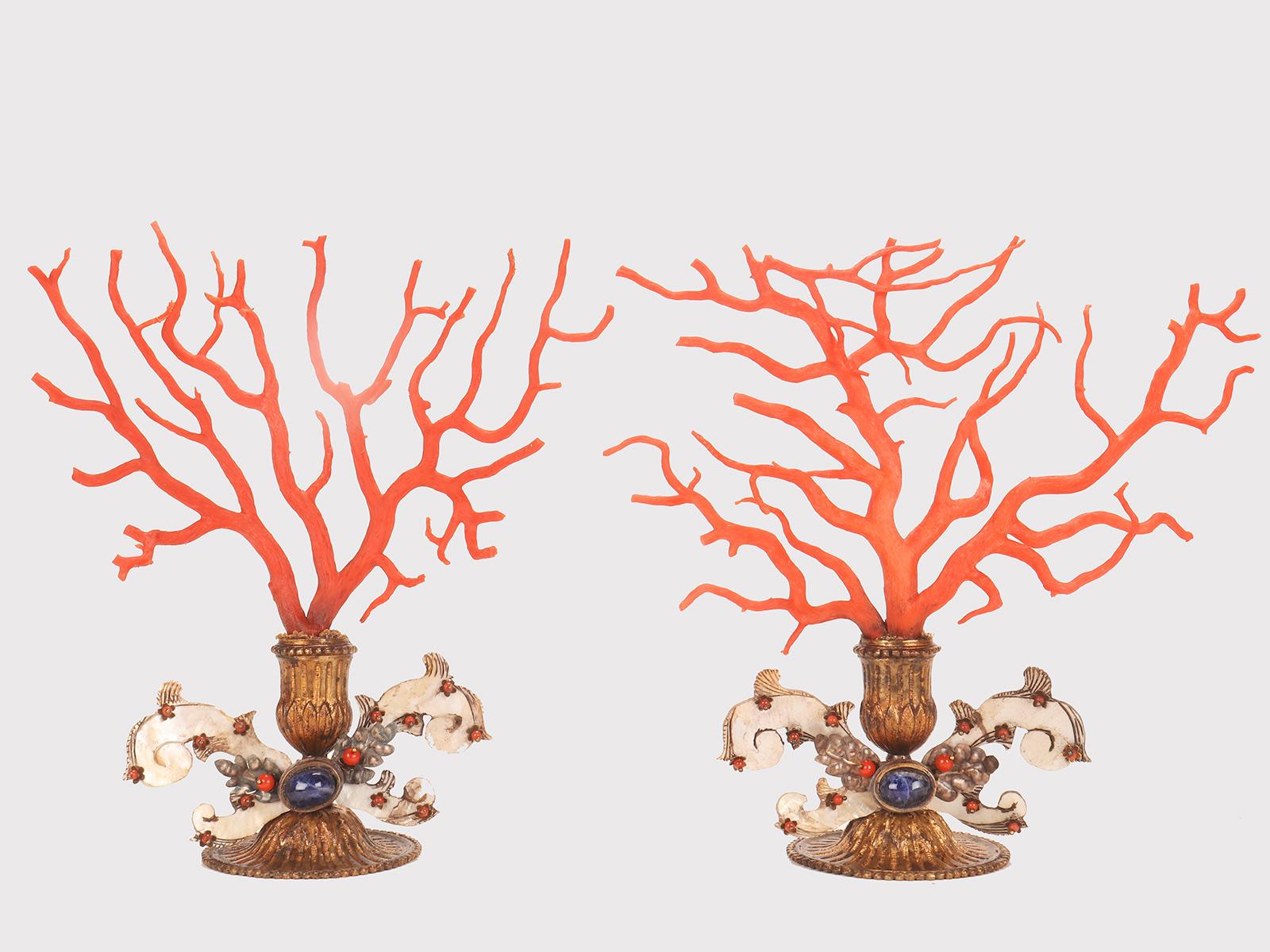 Pair of large branches of Mediterranean red coral (Corallium Rubrum). Gilt bronze bases with phytomorphic calyx stem. Connection with an oval element in Lapis Lazuli and two spirals in engraved mother-of-pearl, enriched with coral pearls. Trapani,