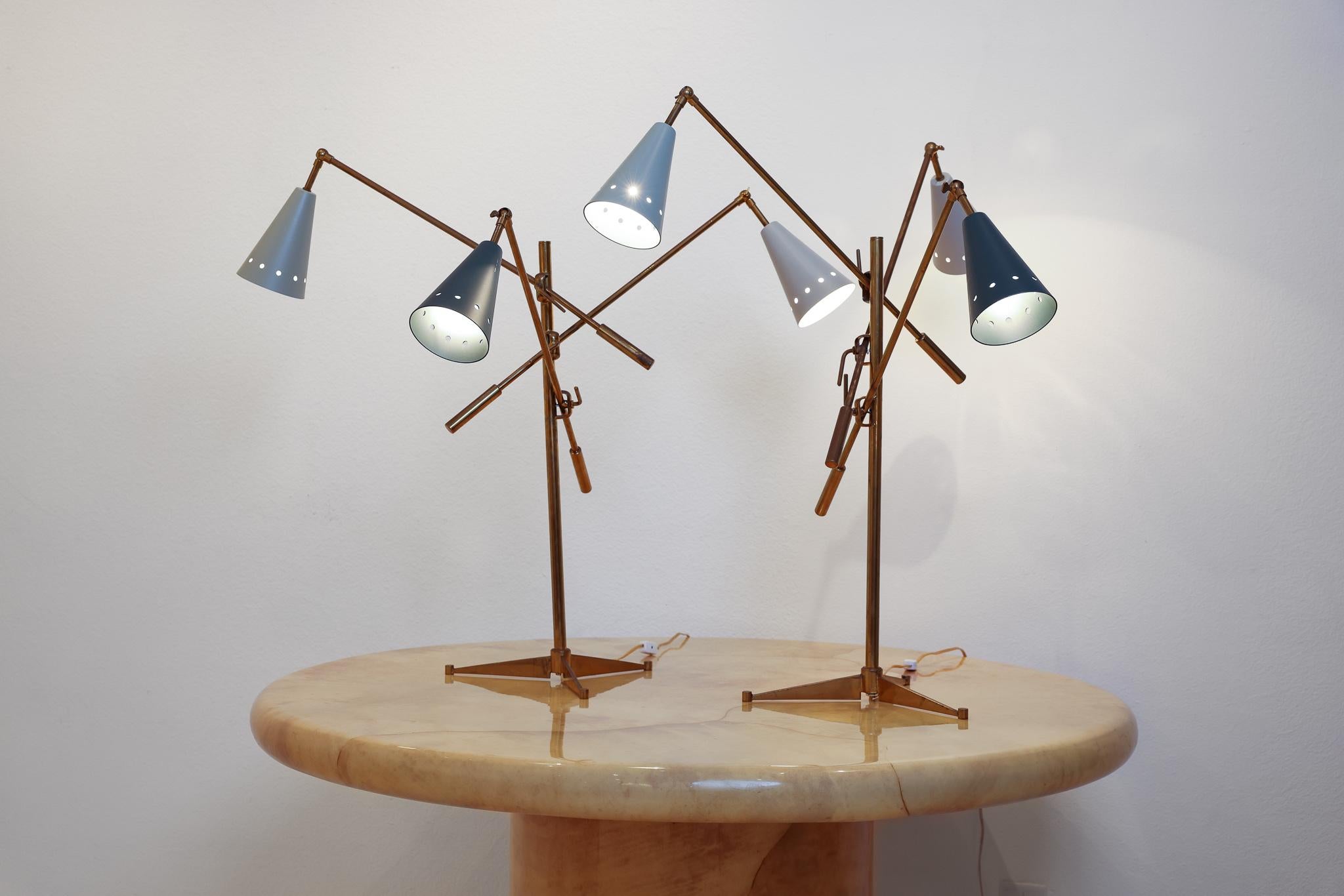 These 2 brass and enamel Triennale style table lamps are in exceptional shape. Circa, 1950's, this sculptural style lighting epitomized mid century decor. Much more readily available as floor lamps, these triennale table lamps are a rare treasure!