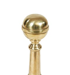 A Pair of Brass Ball Andirons on Cannon Barrel Shafts