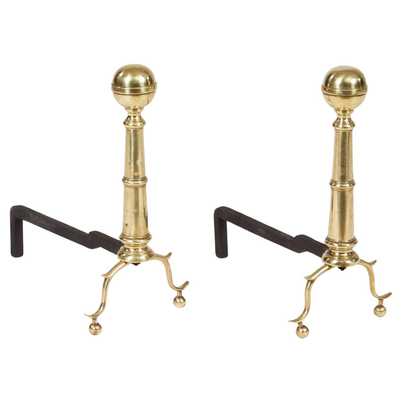 A Pair of Brass Ball Andirons on Cannon Barrel Shafts