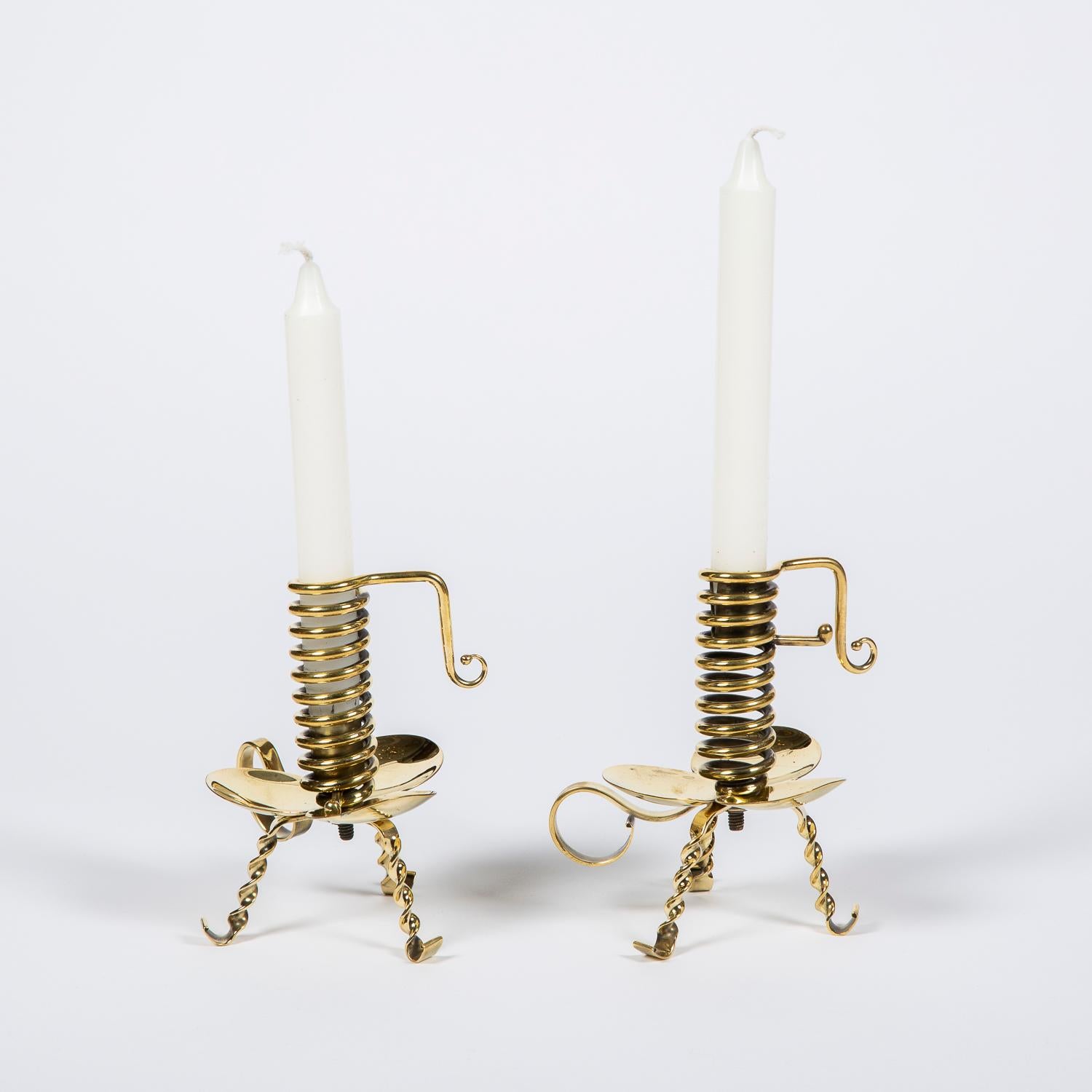 A pair of brass spiral court candlestick.

The candles height can be adjusted by turn the handle within the spiral.

Such candlesticks were used from the 17th century-19th century to light a room were a man had come to court a daughter of a