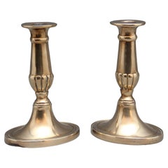 A pair of brass Georgian candlesticks