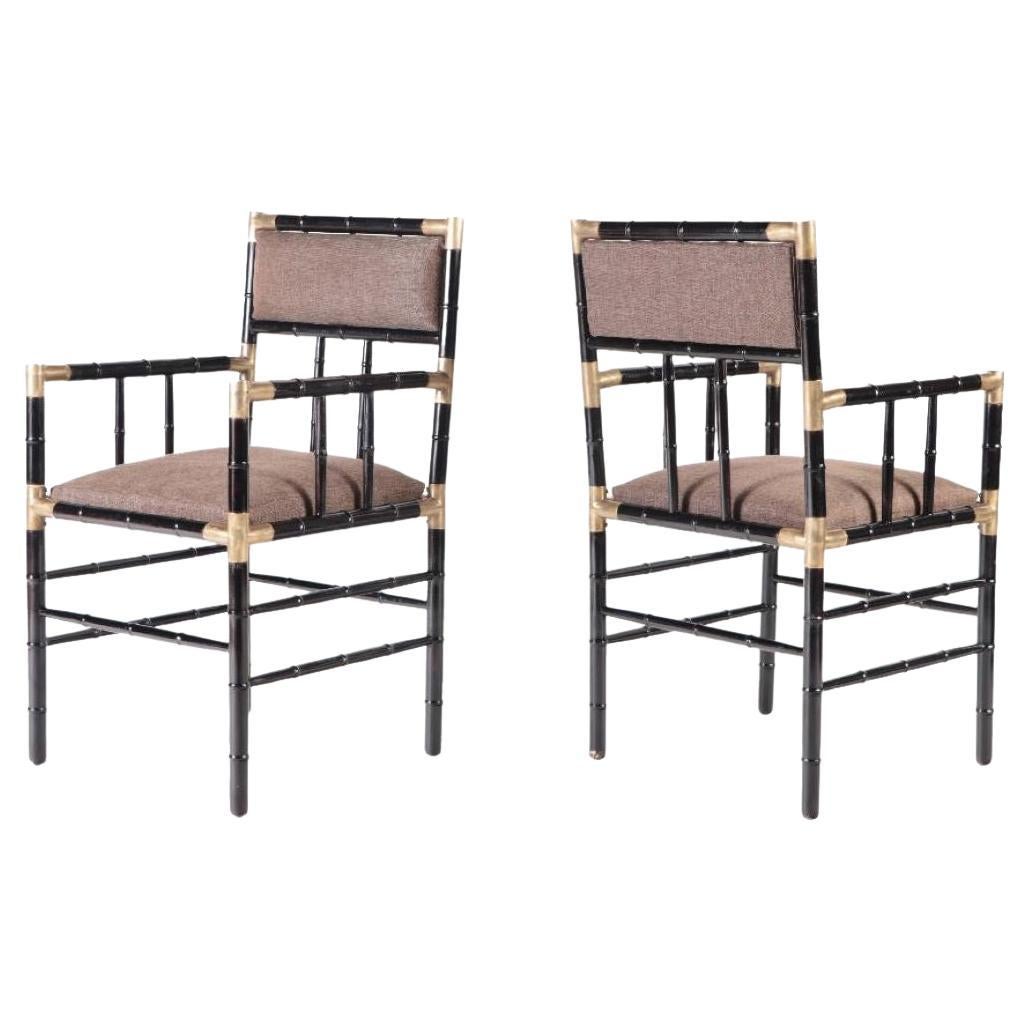 A pair of brass mounted open armchairs in the manner of Billy Haines circa 1950.