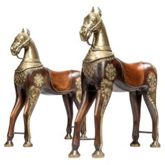 A pair of brass mounted Teak processional horses