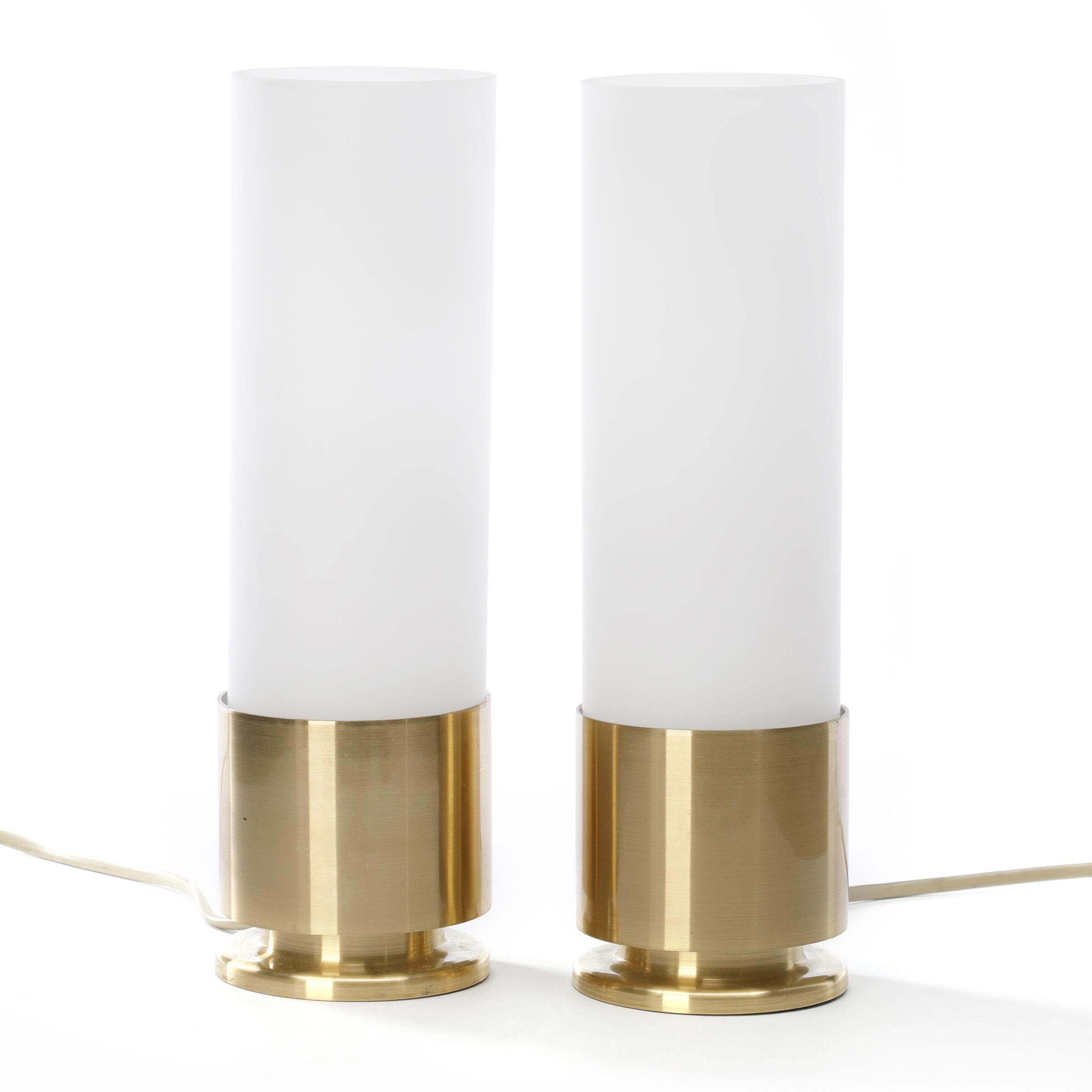 A pair of rare table lamps by Danish designer Jørgen Bo. Made of brass with cylindrical opal glass shades. Designed 1968. Made and branded by Fog & Mørup. H. 27.
This is a table light version of the Jørgen Bo wall light that is more often seen.