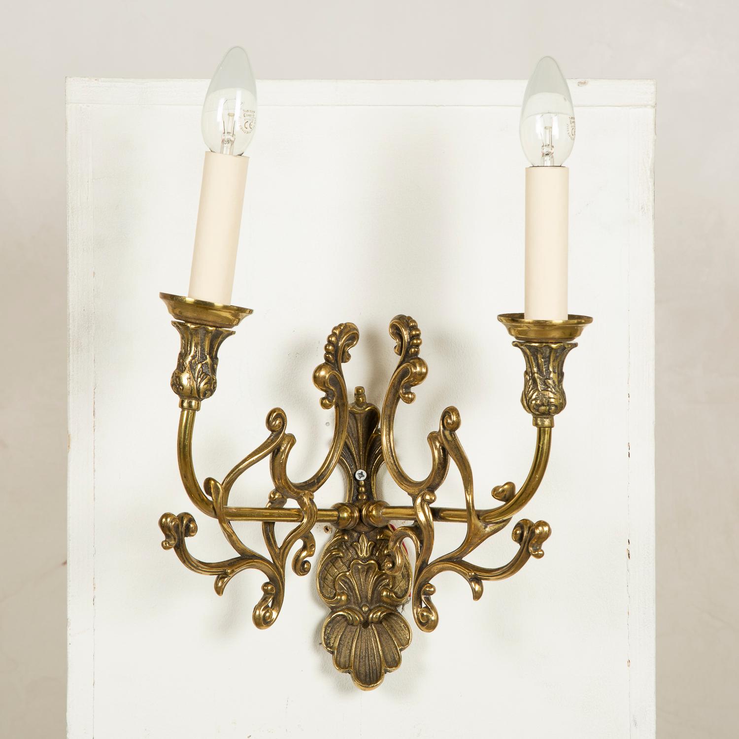 A pair of brass scroll twin arm wall lights.

Rewired and tested.