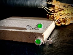 A Pair of Bright Green Jadeite Cabochon and Diamond Earrings in 18 Karat Gold