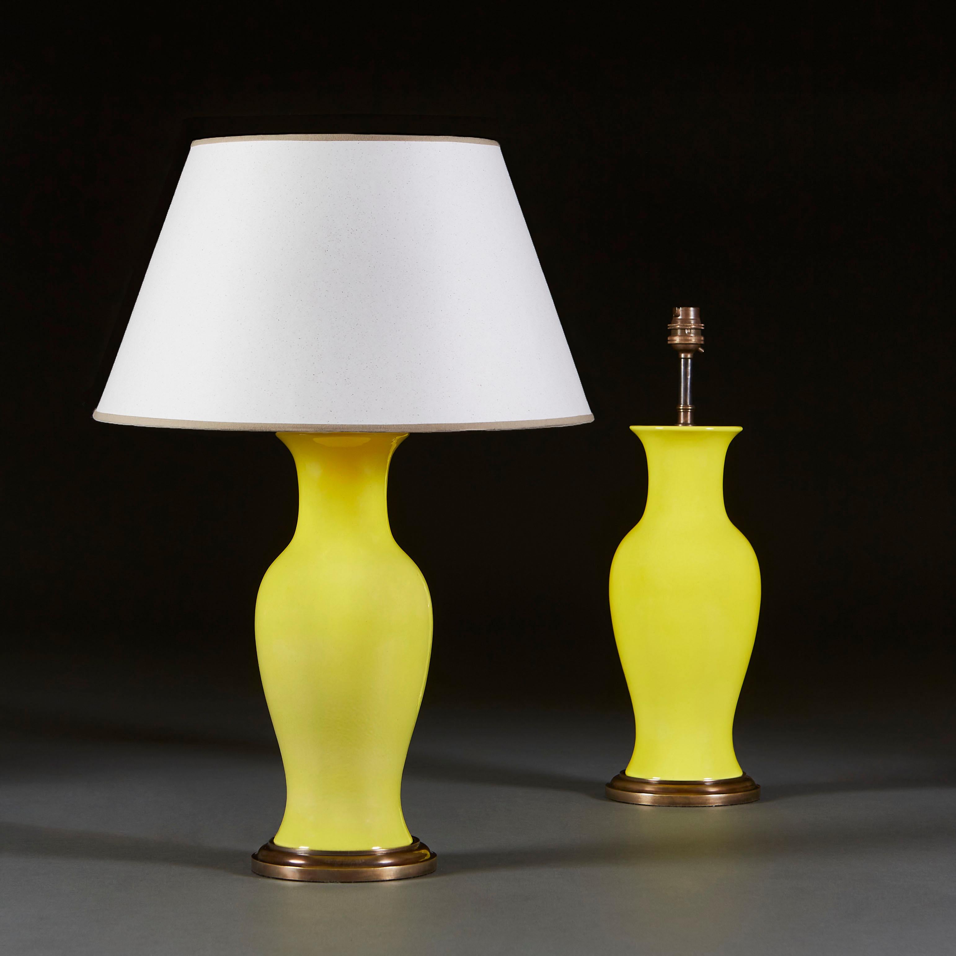 A pair of mid twentieth century Chinese vases of baluster form, with bright lemon yellow glaze, now mounted as lamps with turned brass bases.

Currently wired for the UK.

Please note: lampshades not included.
