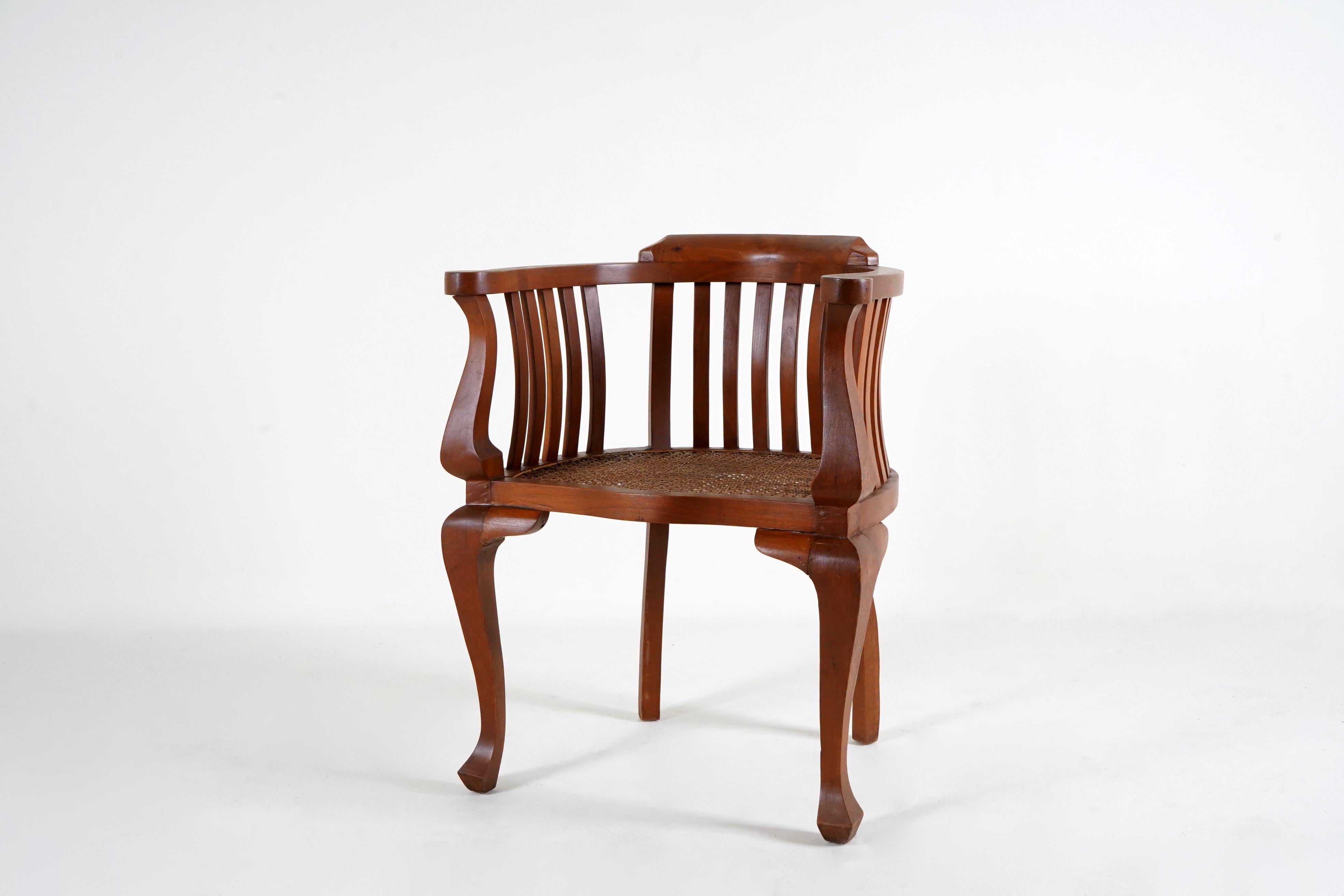 A Pair of British Colonial Teak Arm Chairs With Rattan Seats 1