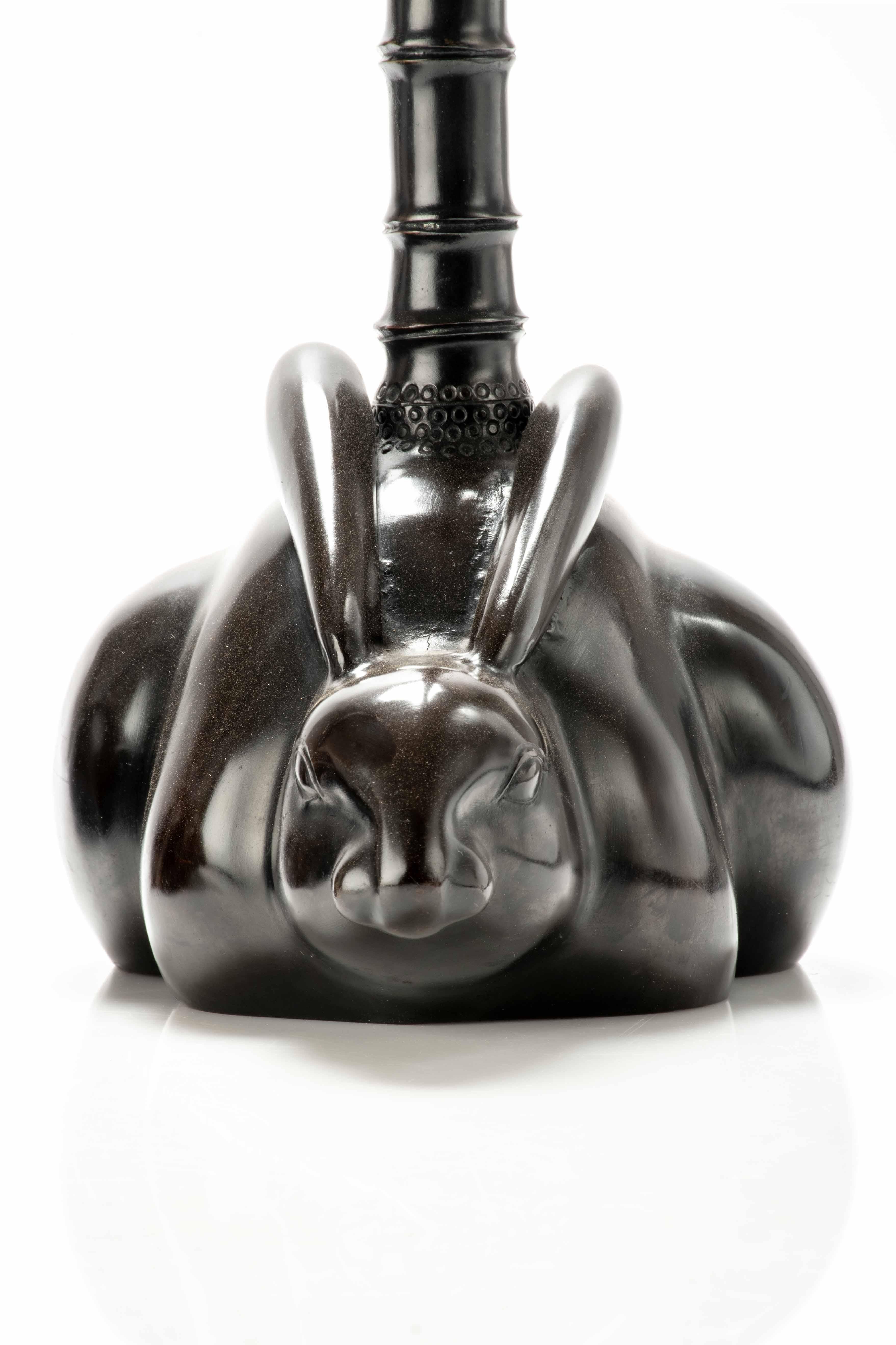 Japanese A pair of bronze candlesticks depicting two rabbits