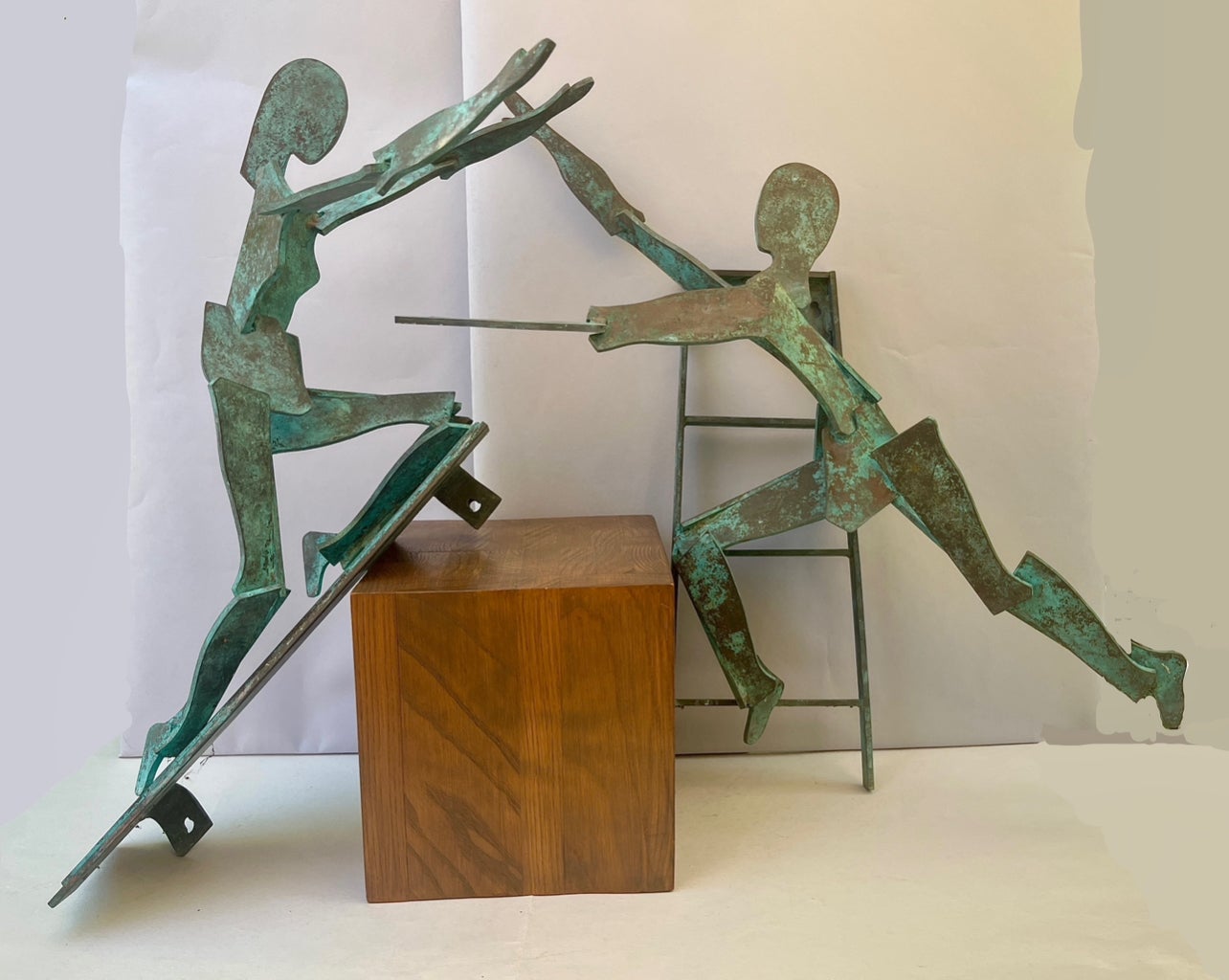 A pair of large bronze figurative wall hanging sculptures, 20th century