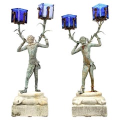 A Pair Of Bronze Monkey Butler Candlesticks