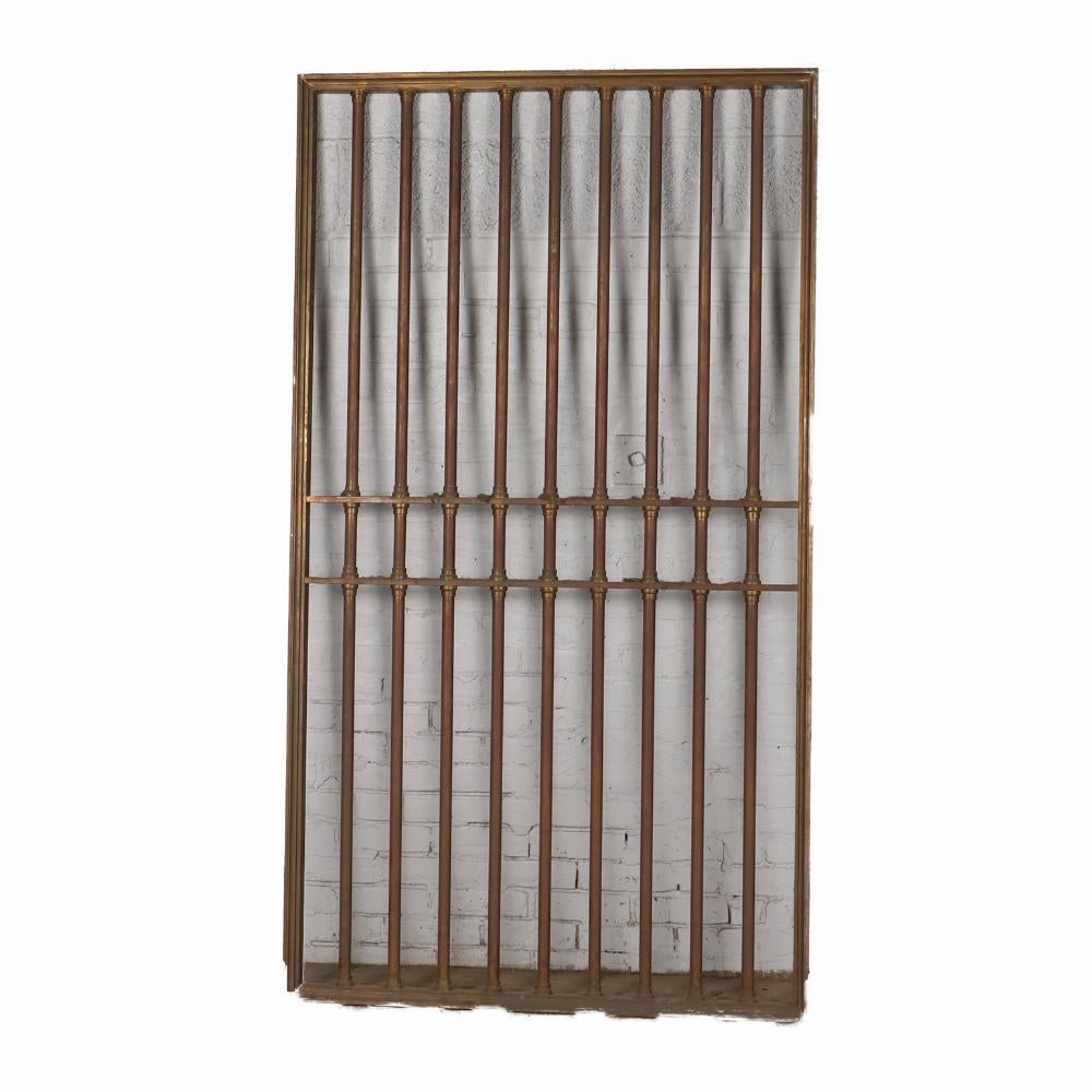 Pair bronze panels from a bank C 1910. Would make a great entry for your home or wine cellar. Each gate / panel / door comprised of 9 turned bars within a picture rail style frame.