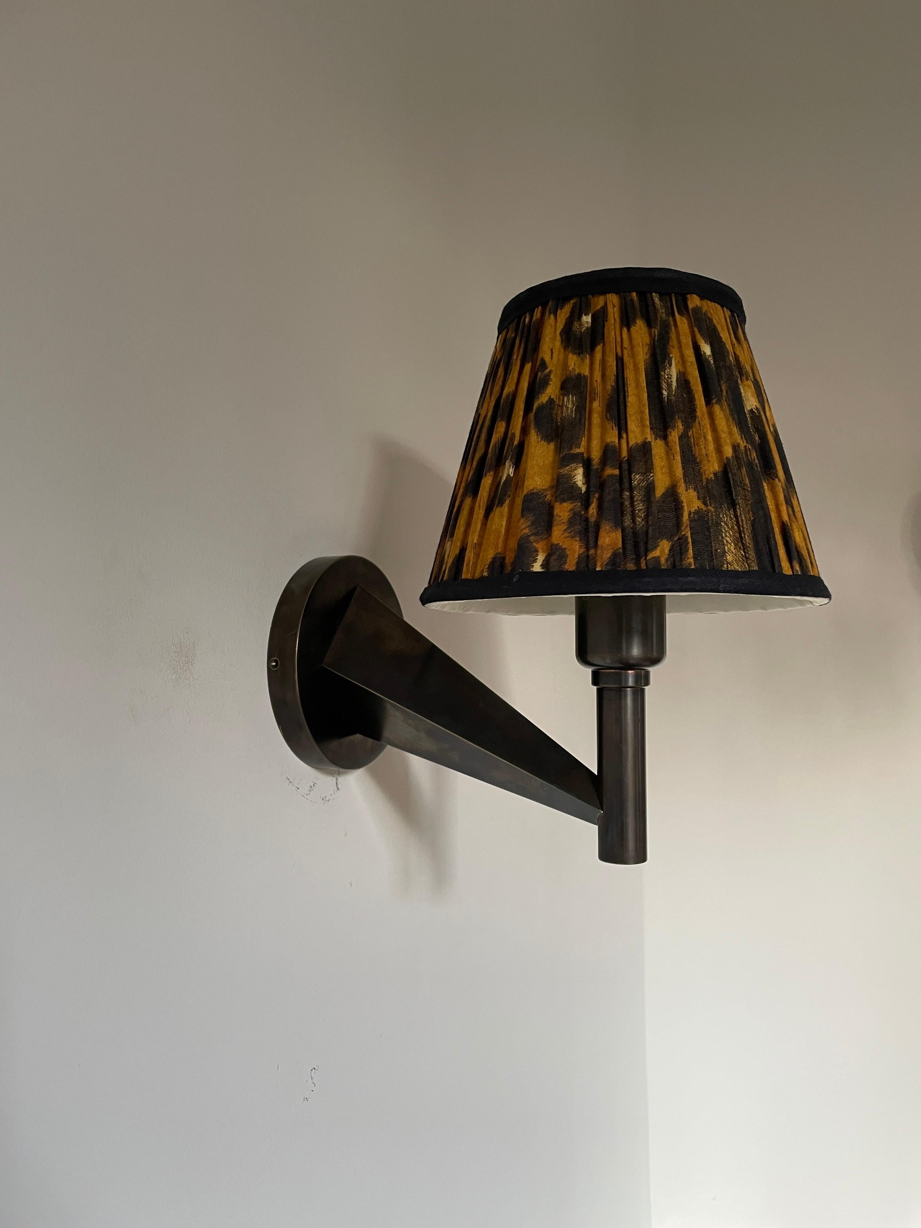 From our Studio Bucchi Collection, these hand made in the UK sconces are available in different finishes. We have used a leopard print shade which is included with these lights. The lamps are solid brass and with a bronze patinated finish. The