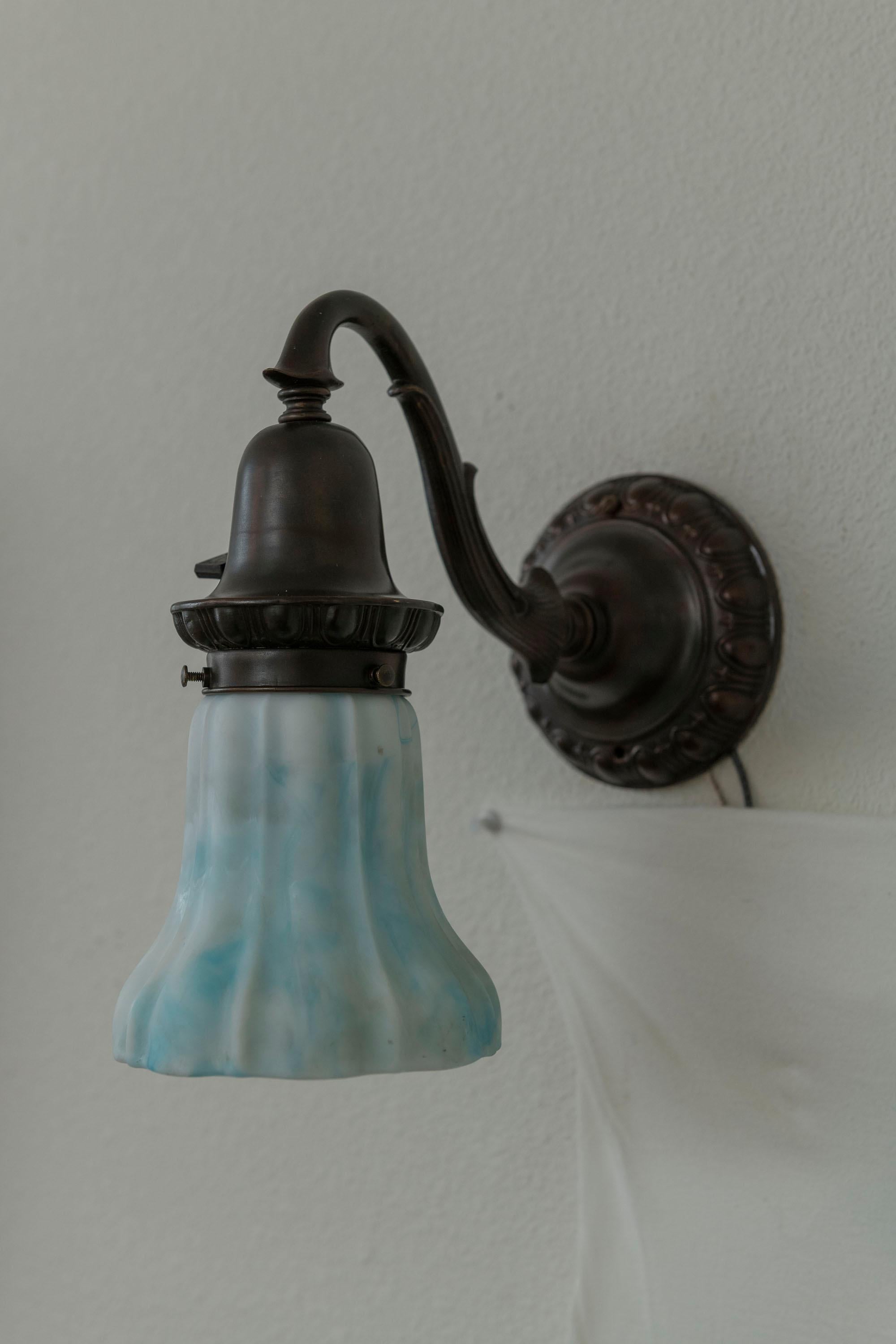 American A Pair of Bronze Sconces with Blue/White Kokomo Co. Glass Shades ca. 1910 For Sale