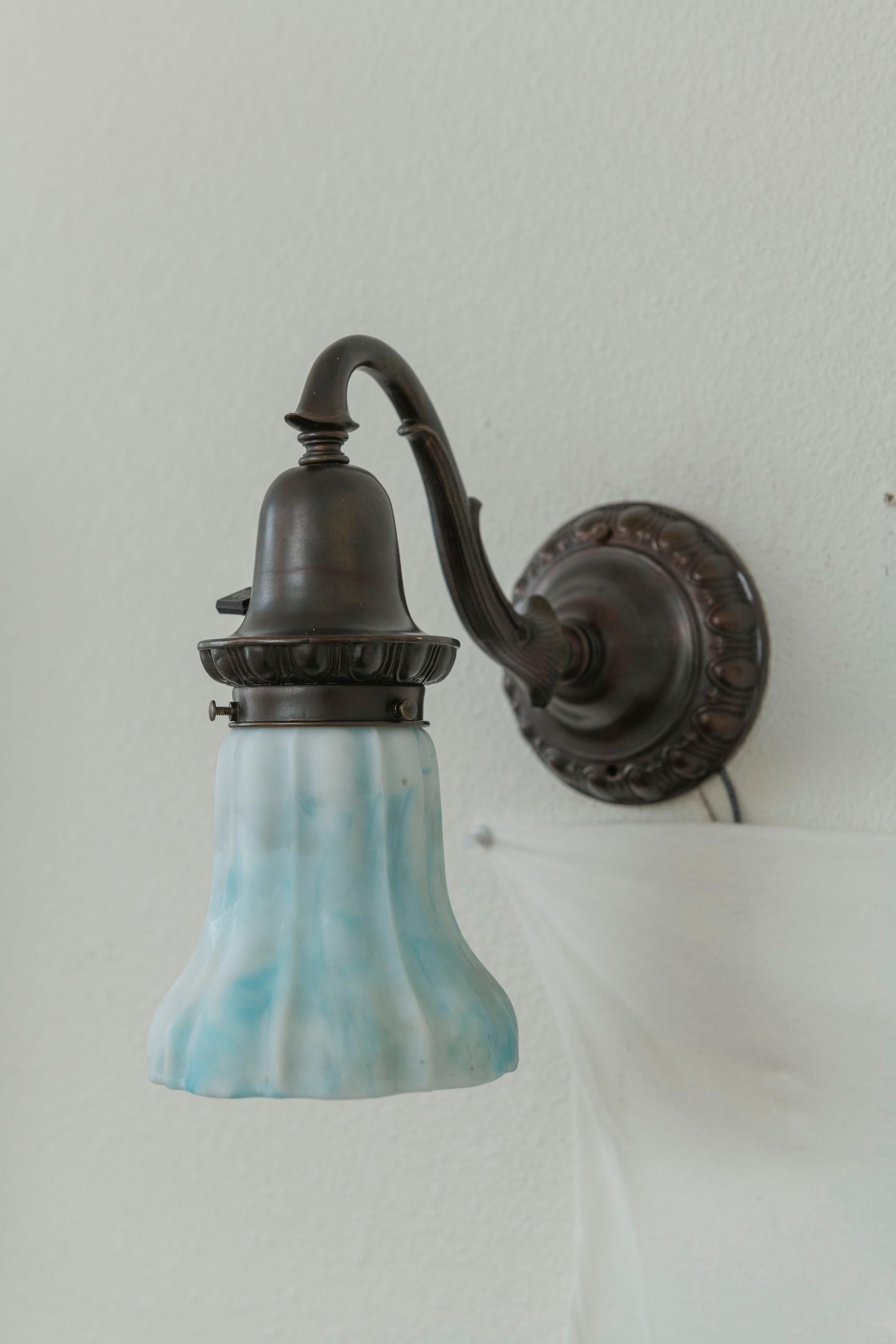 Cast A Pair of Bronze Sconces with Blue/White Kokomo Co. Glass Shades ca. 1910 For Sale