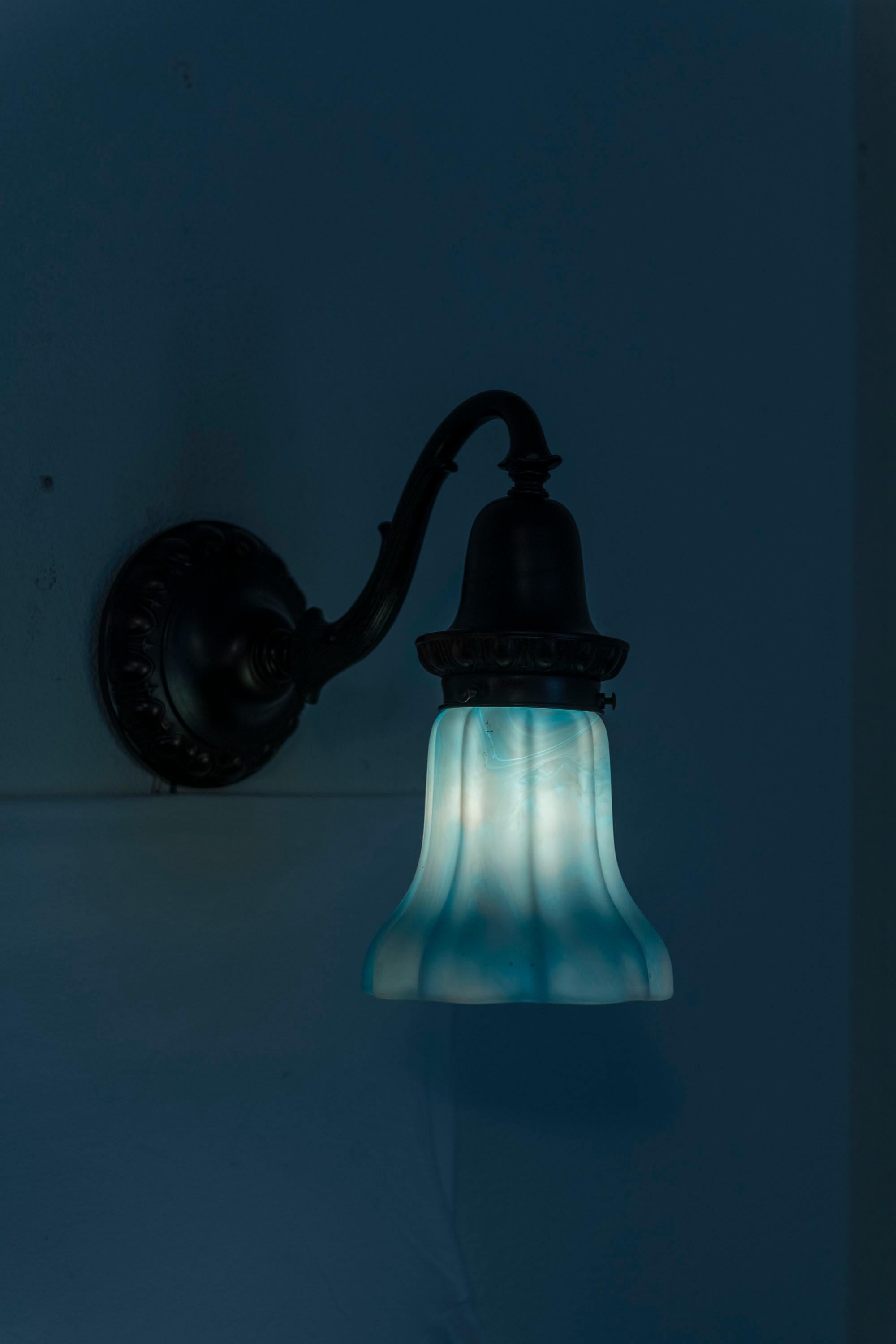 20th Century A Pair of Bronze Sconces with Blue/White Kokomo Co. Glass Shades ca. 1910 For Sale