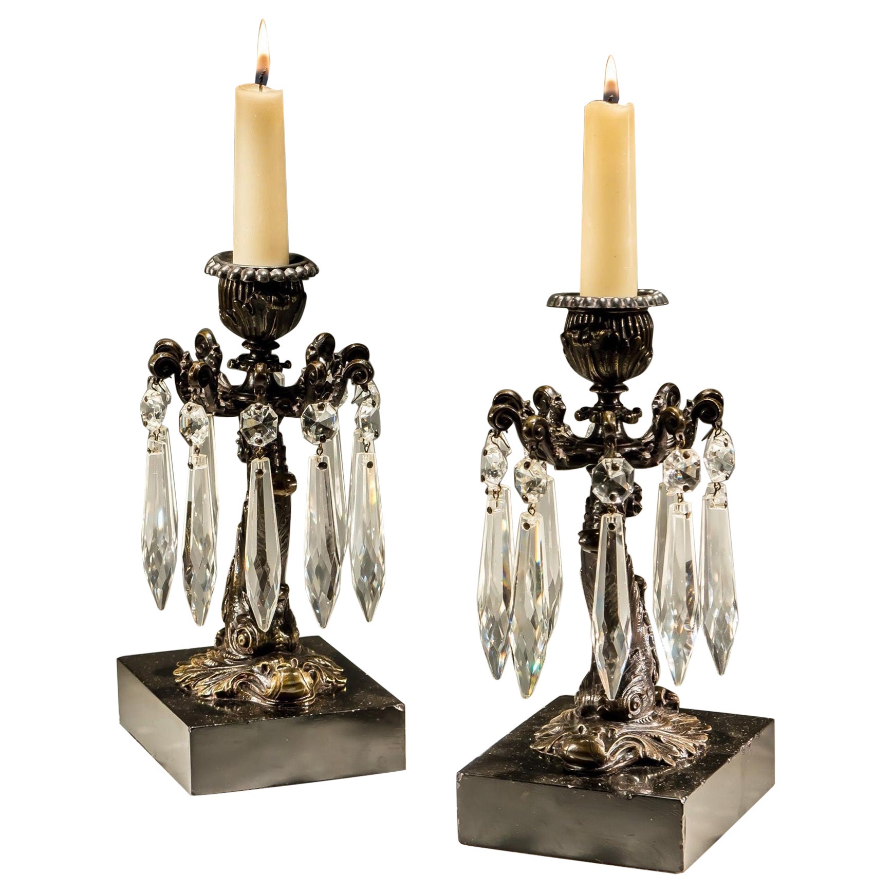 A Pair Of Bronzed Dolphin Candlesticks