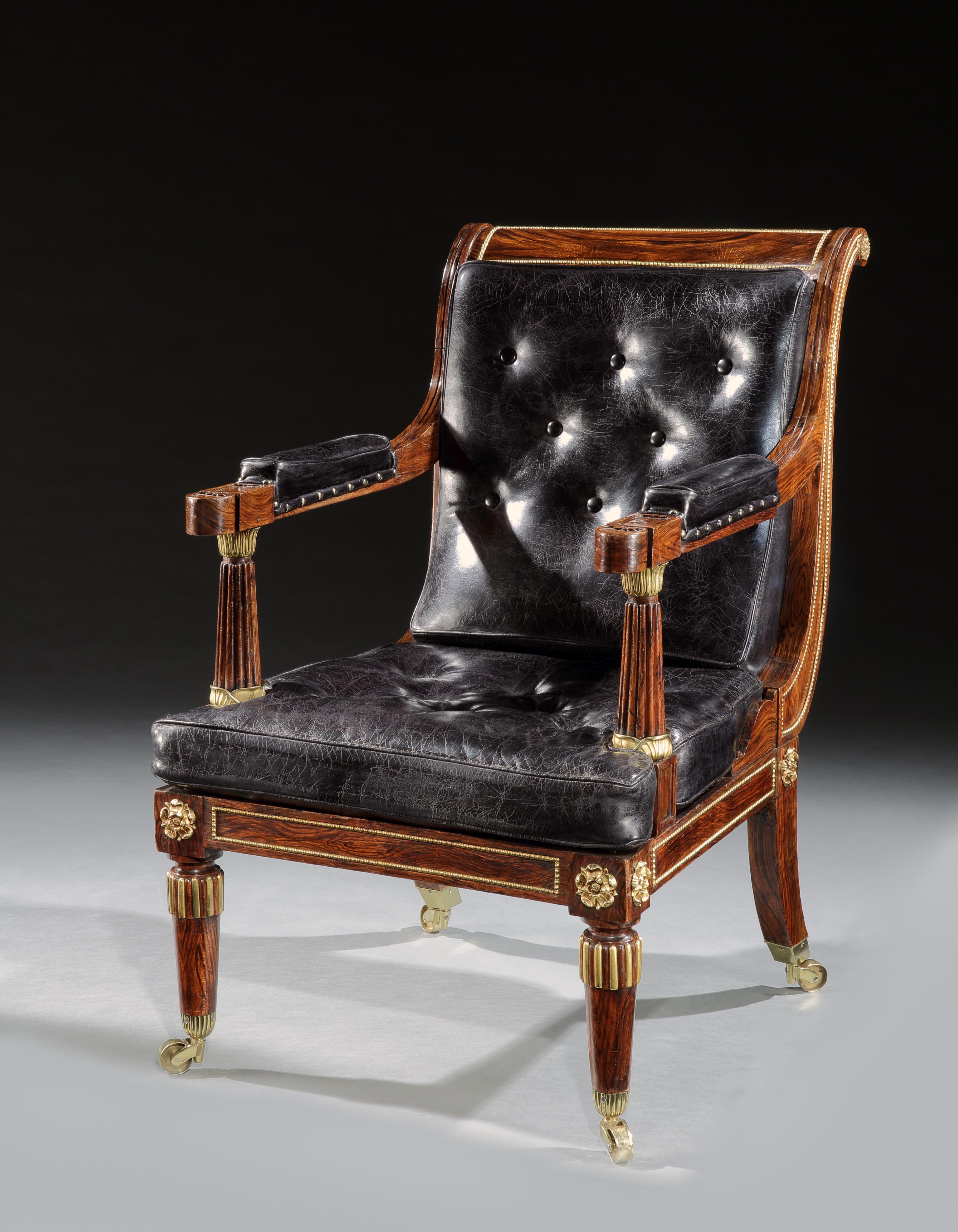A superb pair of George IV simulated rosewood and Ormolu mounted library armchairs of large scale. The scroll over backs with beaded ormolu panels above rectangular seats with fluted arms, mounted with lotus leaf Ormolu, above turned legs with