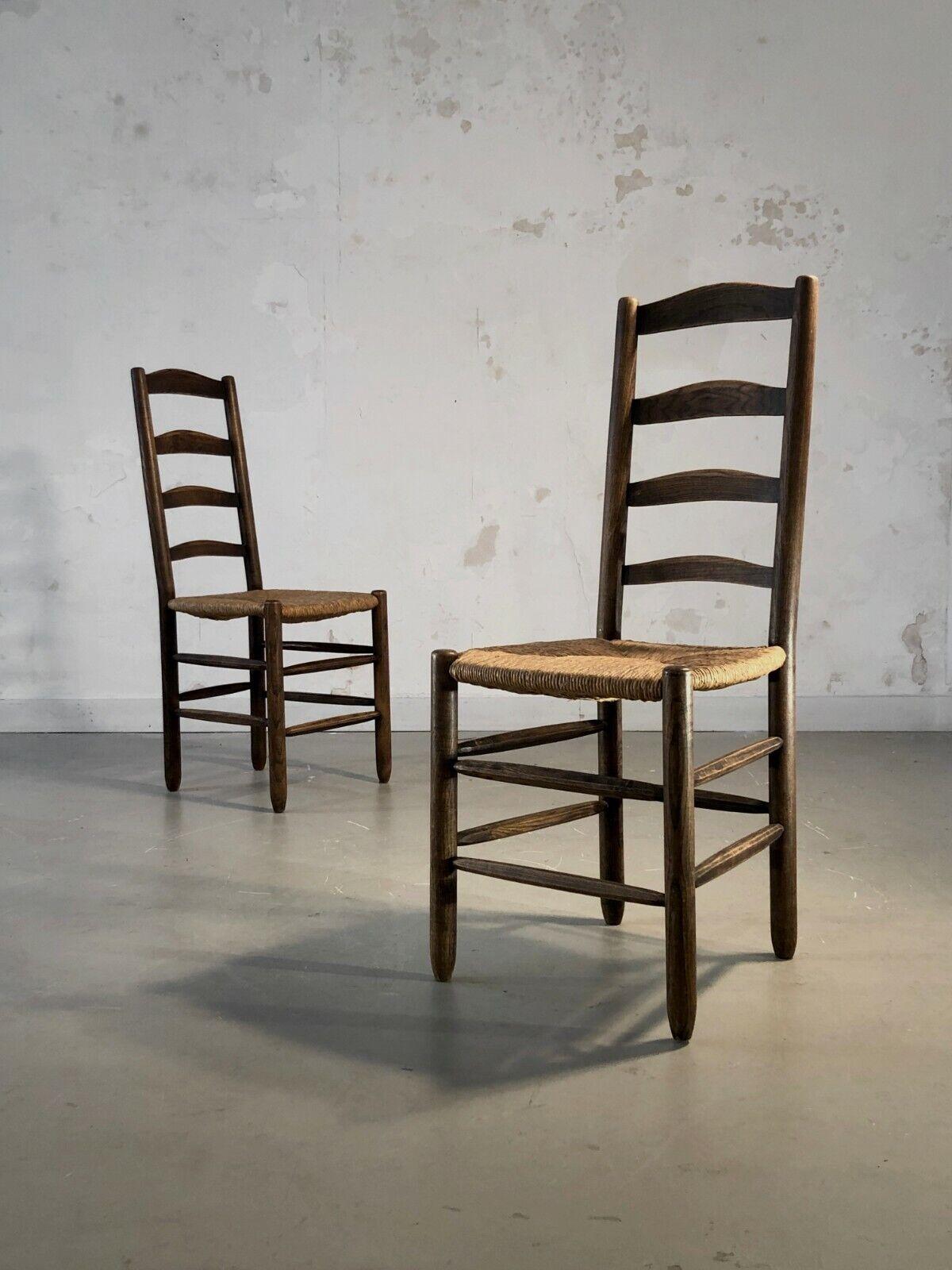 A beautiful pair of 2 chairs with high backs, Modernist, Rustic-Modern, Art-Popular, hand-cut tapered wooden structures, straw seats, high backs, in the spirit of Charles Dudouyt, to be attributed, France 1950.

DIMENSIONS of each chair: H 100 x L