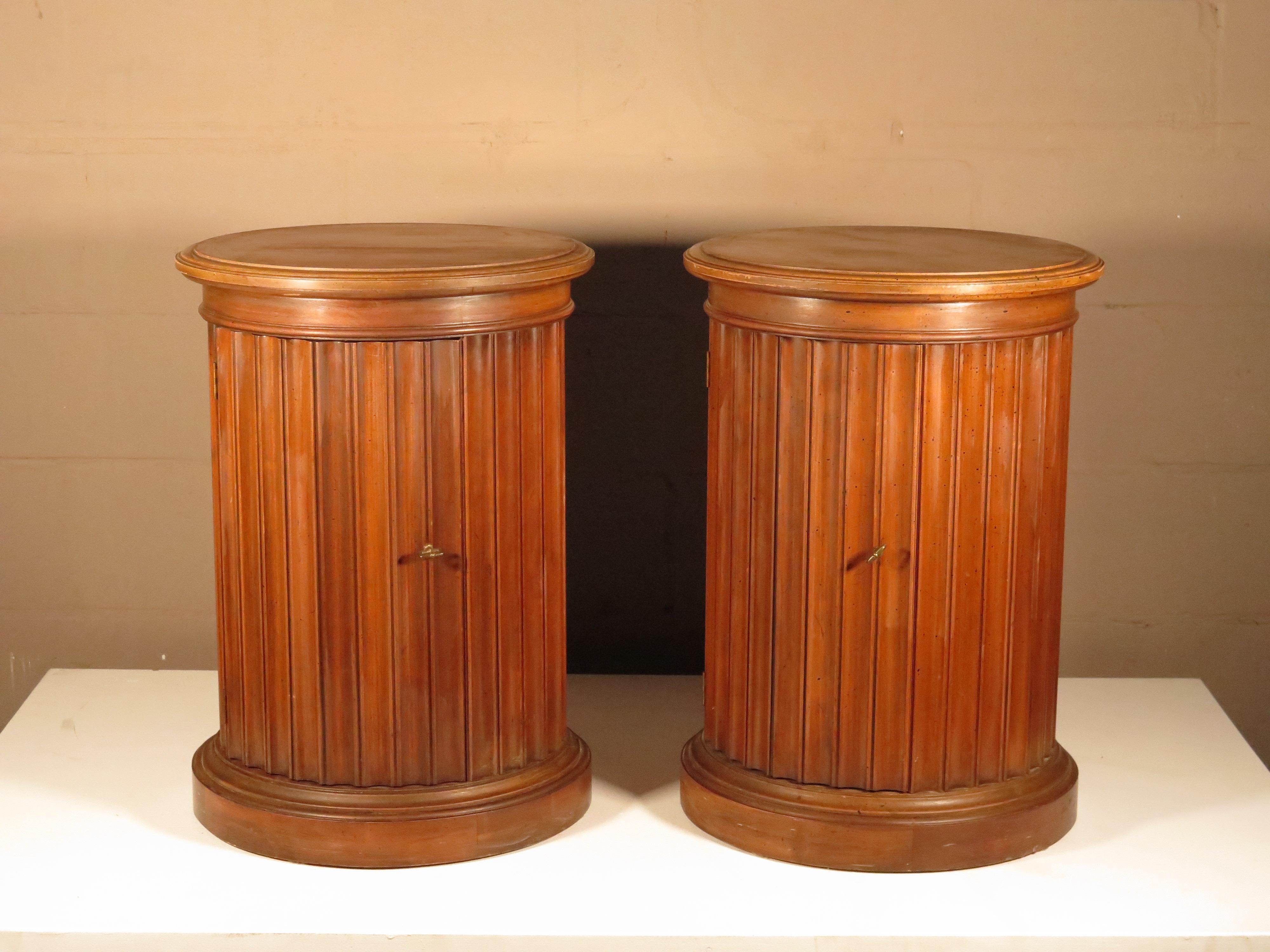 A pair of burl wood pedestals with original speckled finish. Brass key as handles (no locks) open inside for storage. Made by Brandt Co. of Maryland circa 1970. Measuring 25