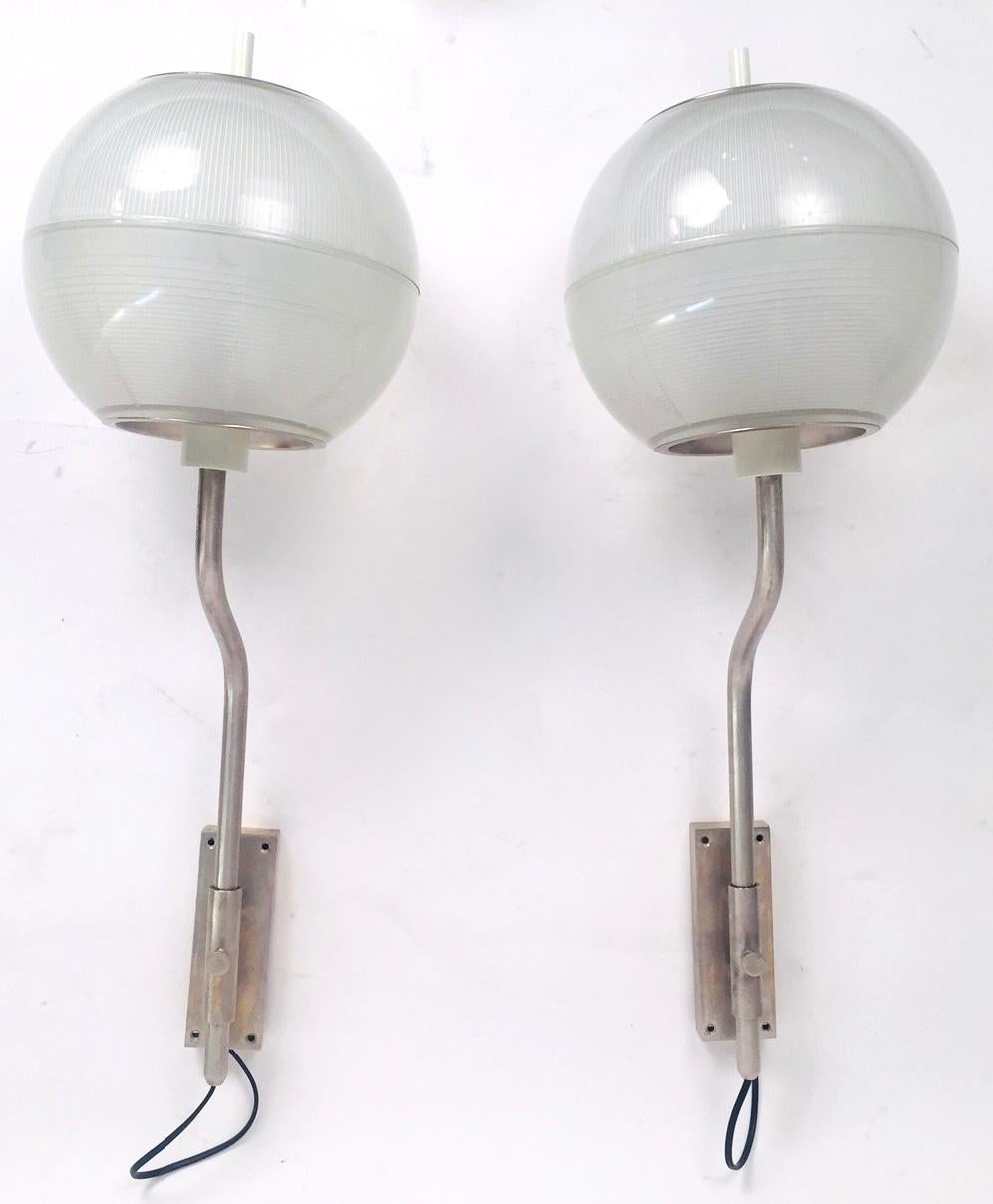 A pair of sconces in the style of Luigi Caccia Dominioni .Pressed glass and patinated steel.Excellent vintage condition .Edted in the sixties.Free professional packing and shipping is provided