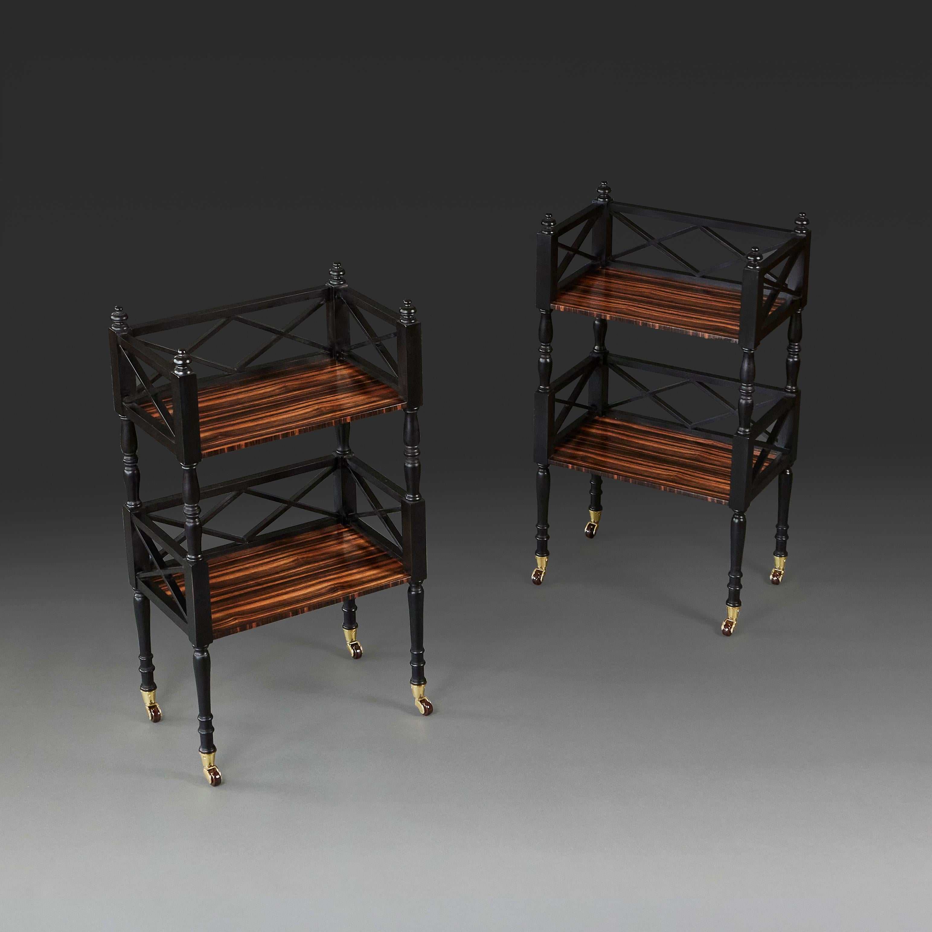 England, modern. 

A pair of calamander two tier etageres of recent manufacture, with enclosed latticed galleries in ebonised wood, with finials to the top, and terminating in brass castors.

Overall height   79.00cm
Height to tabletop 