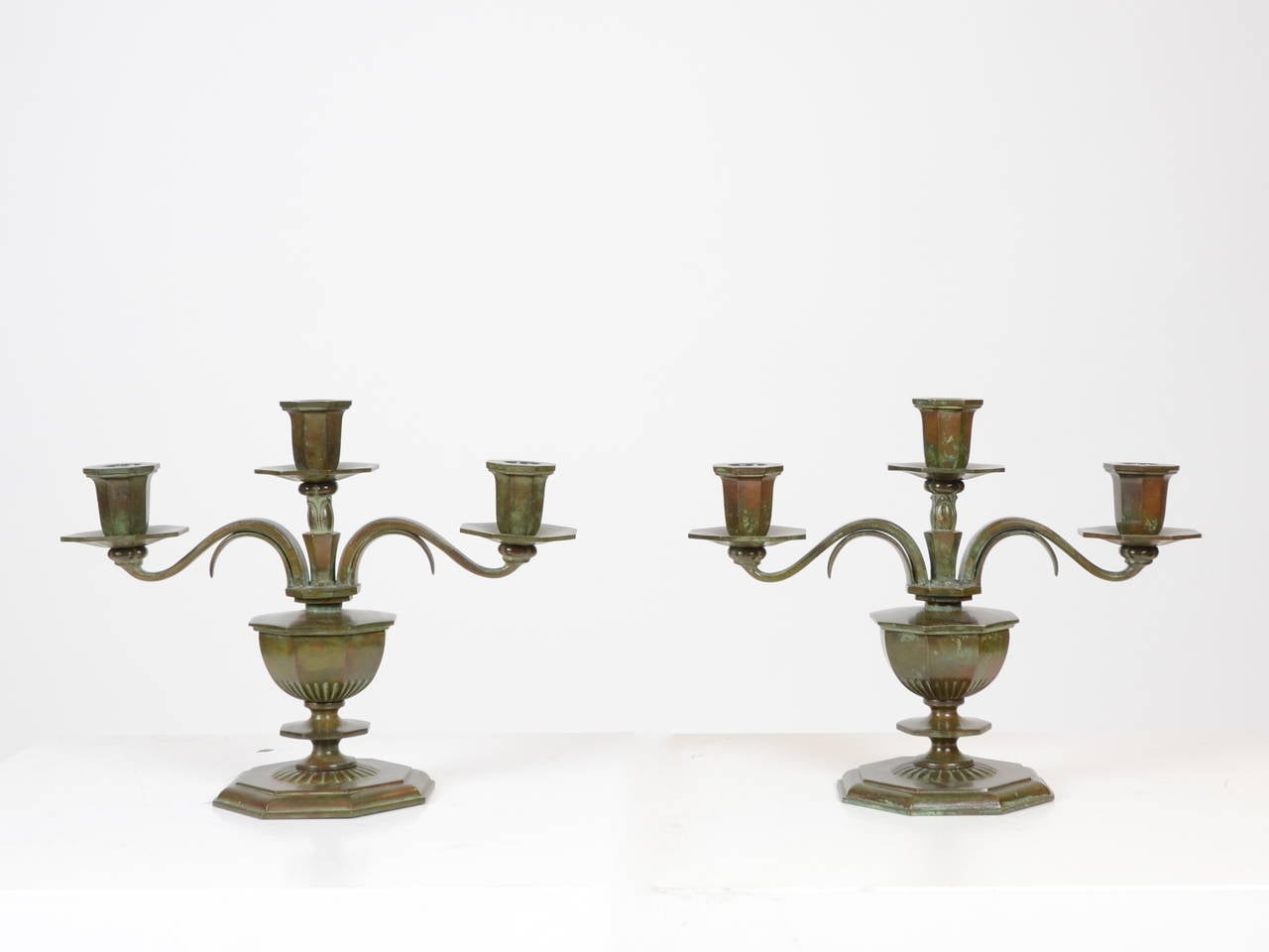A pair of patinated massive bronze candelabra, by Sune Bäckström. Sweden, 1920s-1930s.