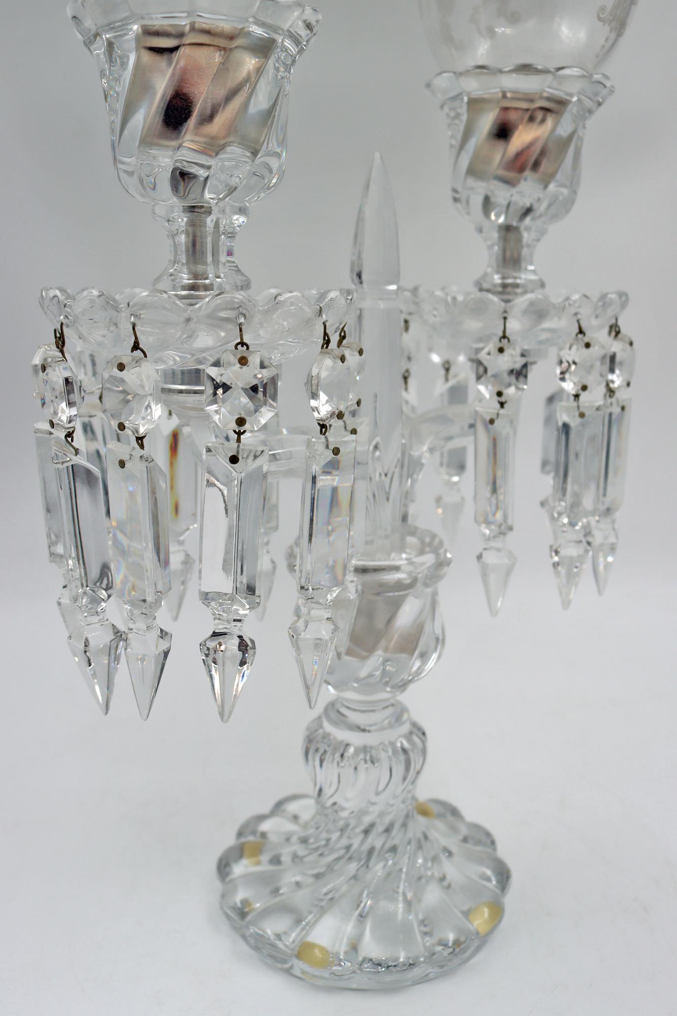 A pair of candelabras signed Baccarat, two Branches with its Baccarat photophores, 19th century, Napoleon III period.
Measures: H: 58 cm, W: 27 cm, D: 12 cm.