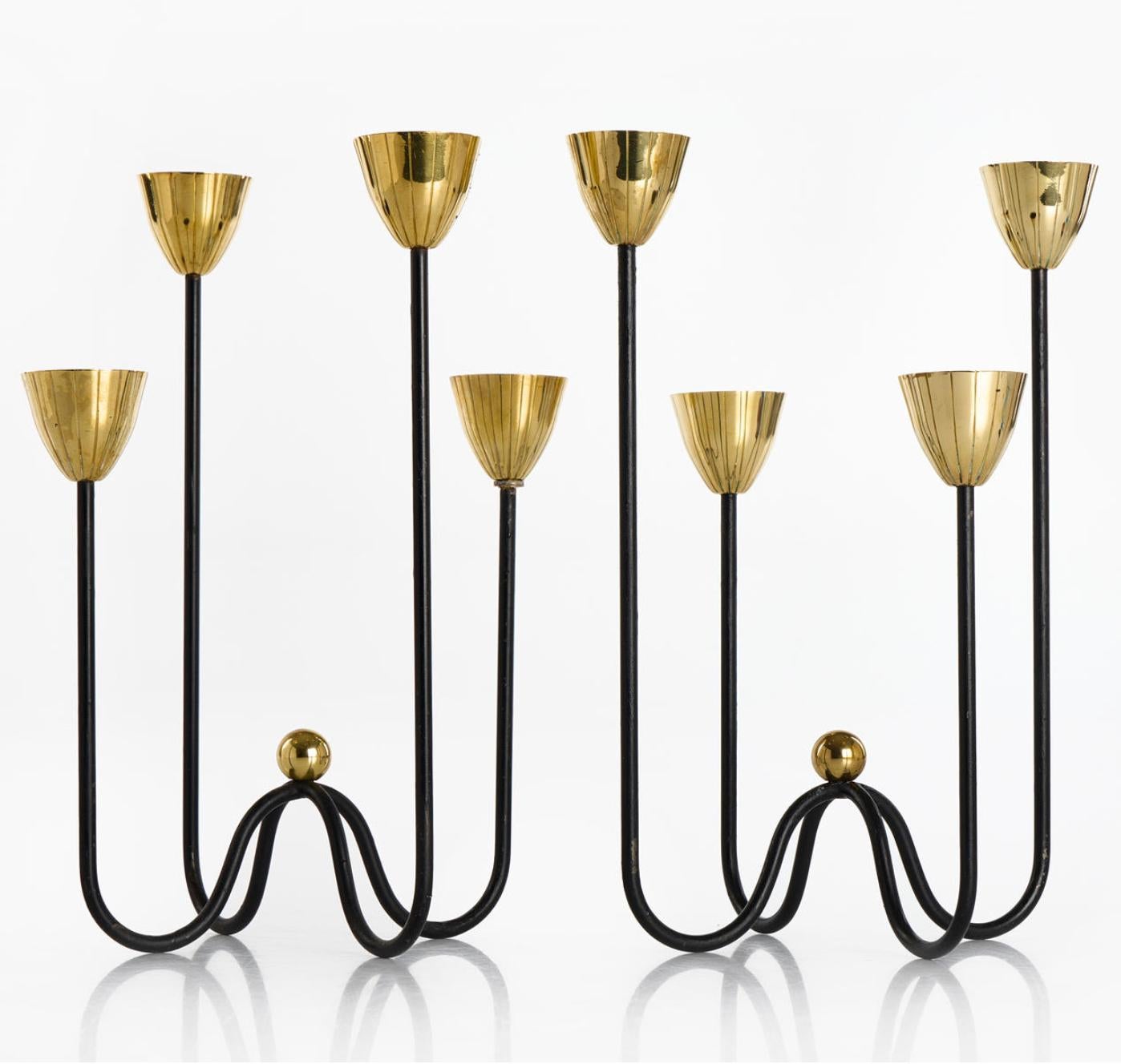 A pair of candleholders by GUNNAR ANDER for Ystad Metall, 1950s. Black lacquered metal and polished brass.