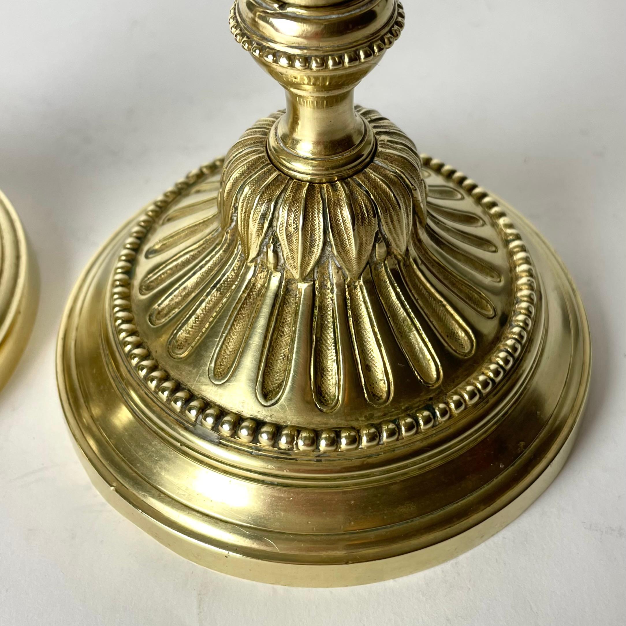 Brass A Pair of Candlesticks in brass, early 20th Century, in the style of Louis XVI For Sale