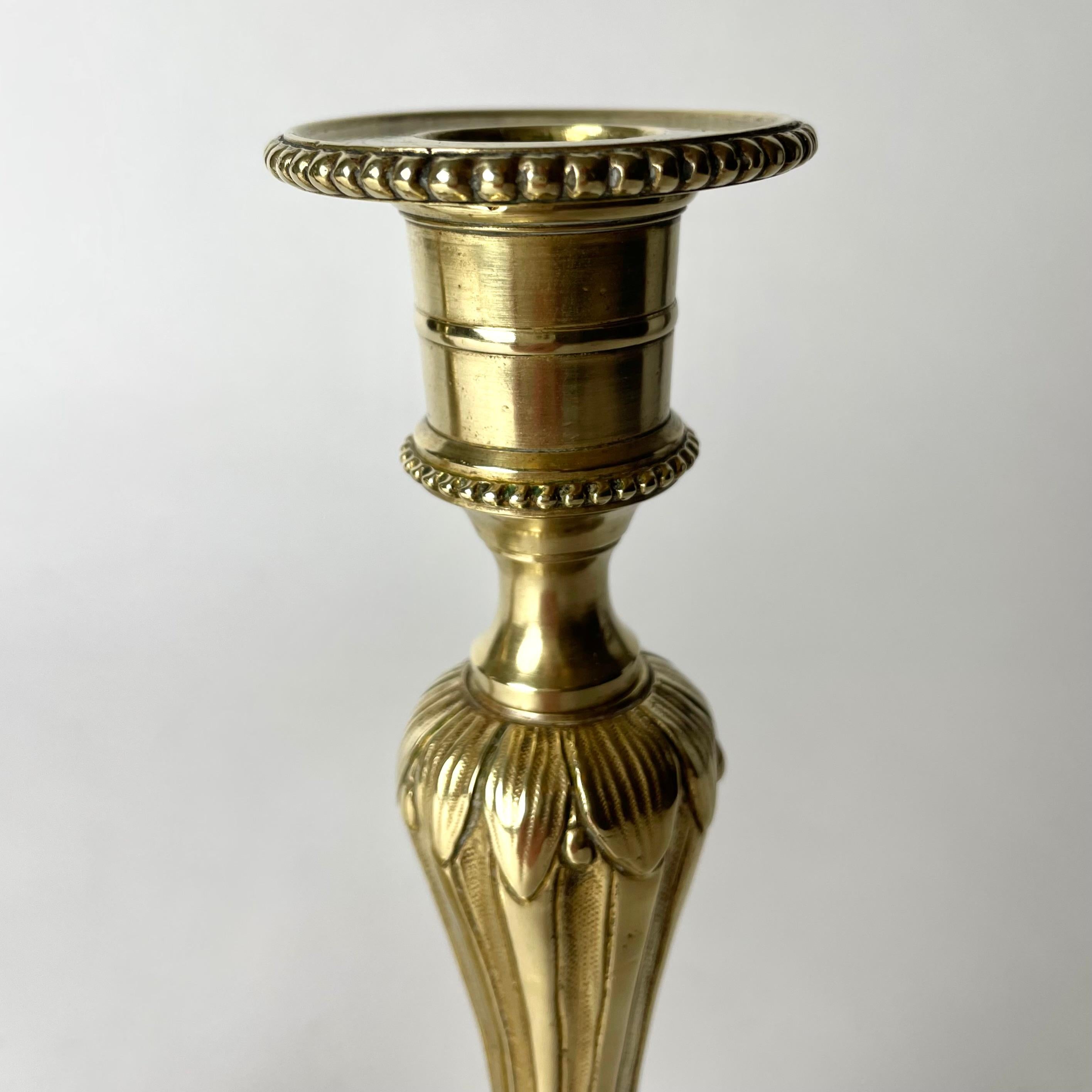 A Pair of Candlesticks in brass, early 20th Century, in the style of Louis XVI For Sale 2