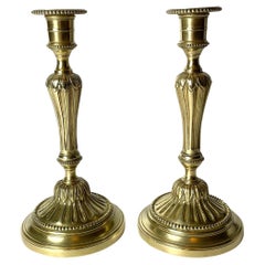 Antique A Pair of Candlesticks in brass, early 20th Century, in the style of Louis XVI