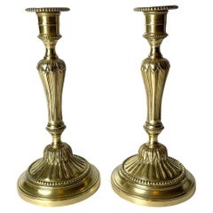 A Pair of Candlesticks in brass, early 20th Century, in the style of Louis XVI