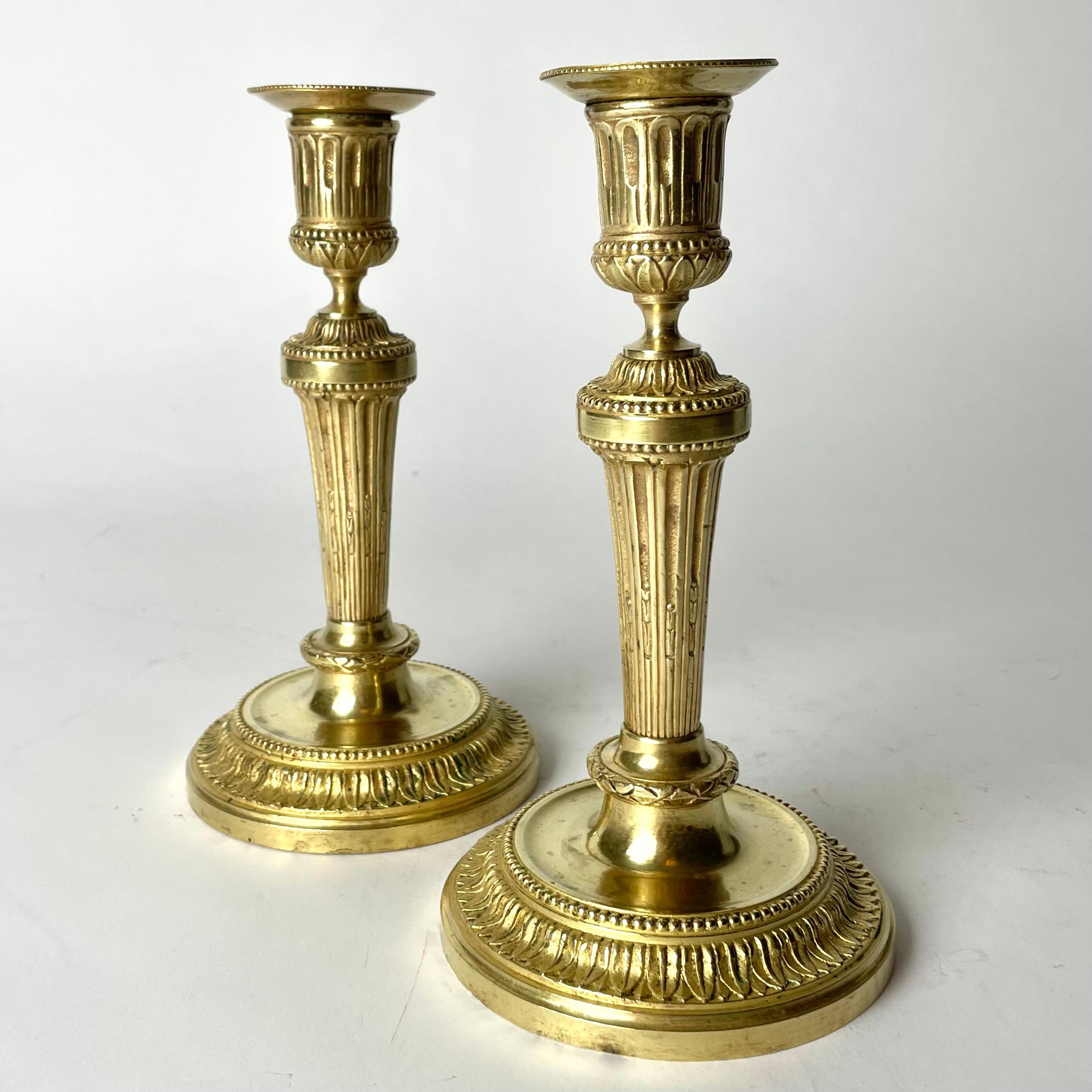A Pair of Elegant and Ornate Gilt Bronze Candlesticks from the 19th Century. In the style of Directoire.


Wear consistent with age and use