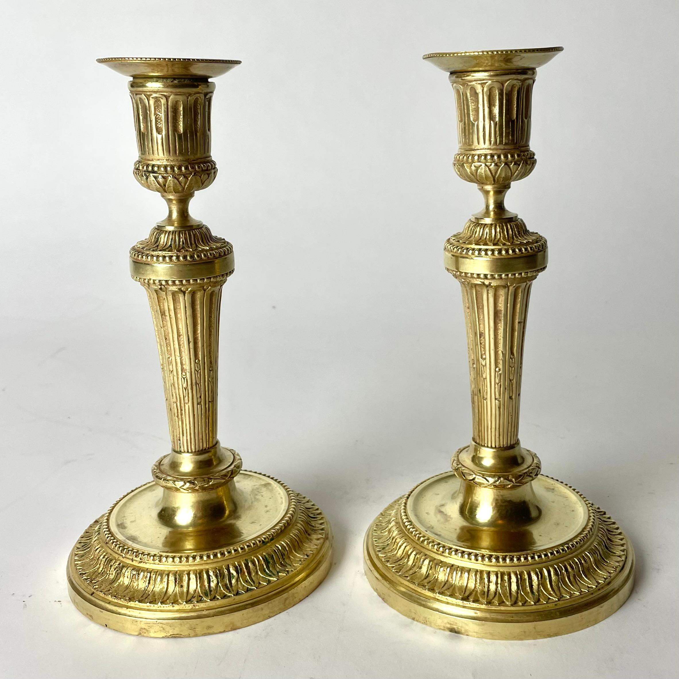 French A Pair of Candlesticks in Gilt Bronze, 19th Century, in the style of Directoire For Sale