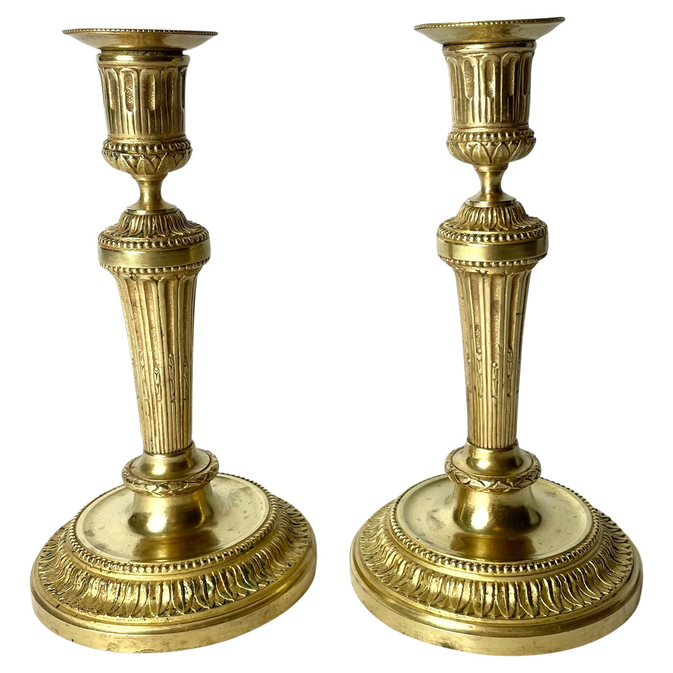 A Pair of Candlesticks in Gilt Bronze, 19th Century, in the style of Directoire For Sale