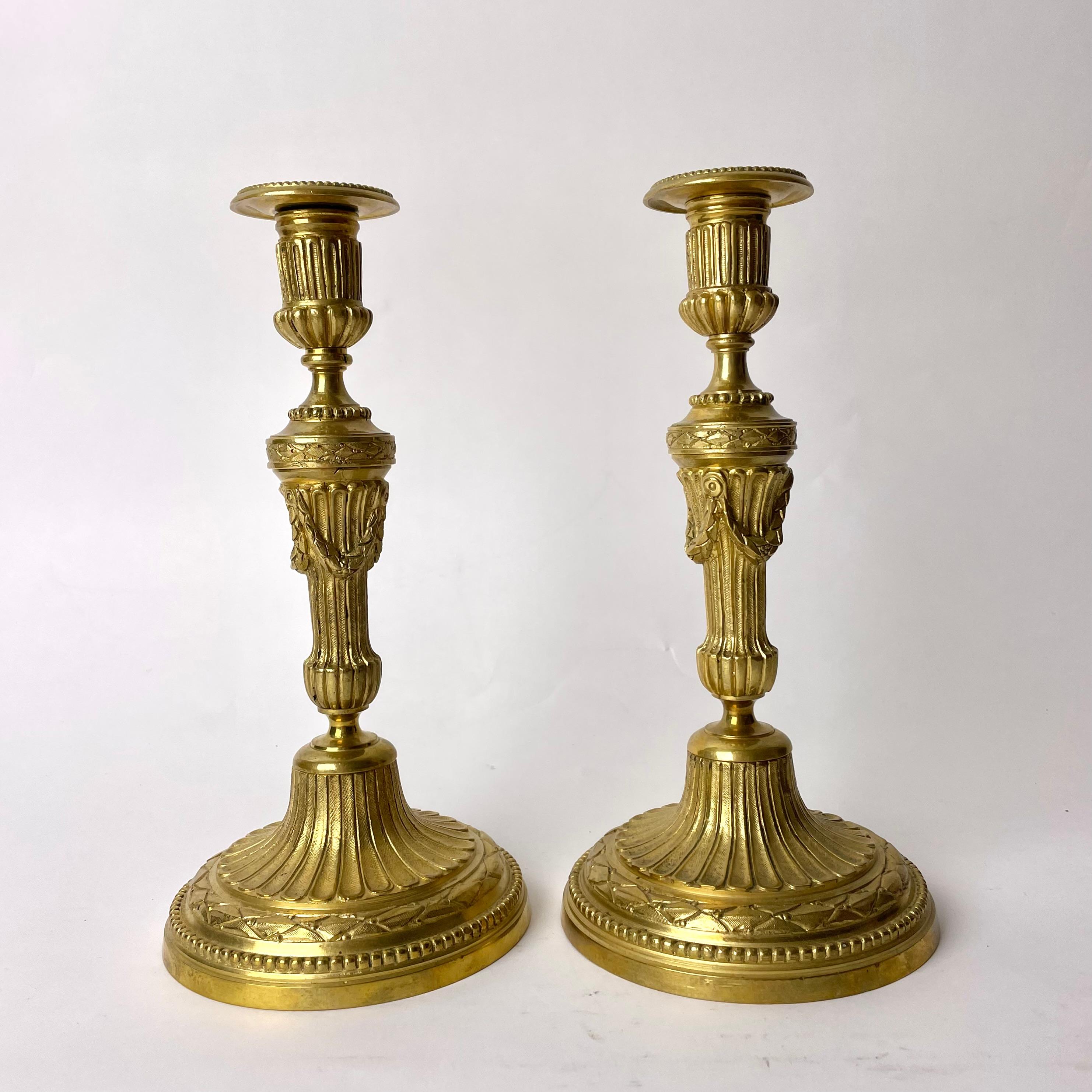 European A Pair of Candlesticks in Gilt Bronze, 19th Century, in the style of Louis XVI For Sale