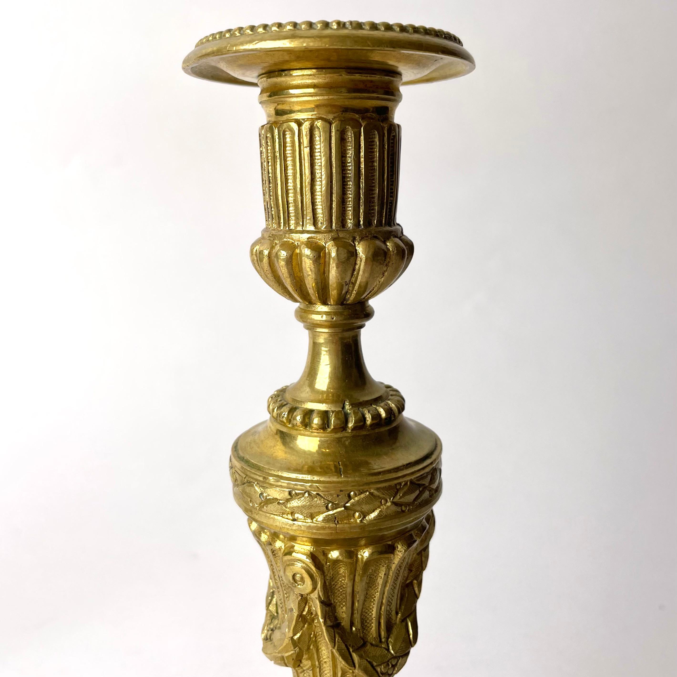 A Pair of Candlesticks in Gilt Bronze, 19th Century, in the style of Louis XVI For Sale 1