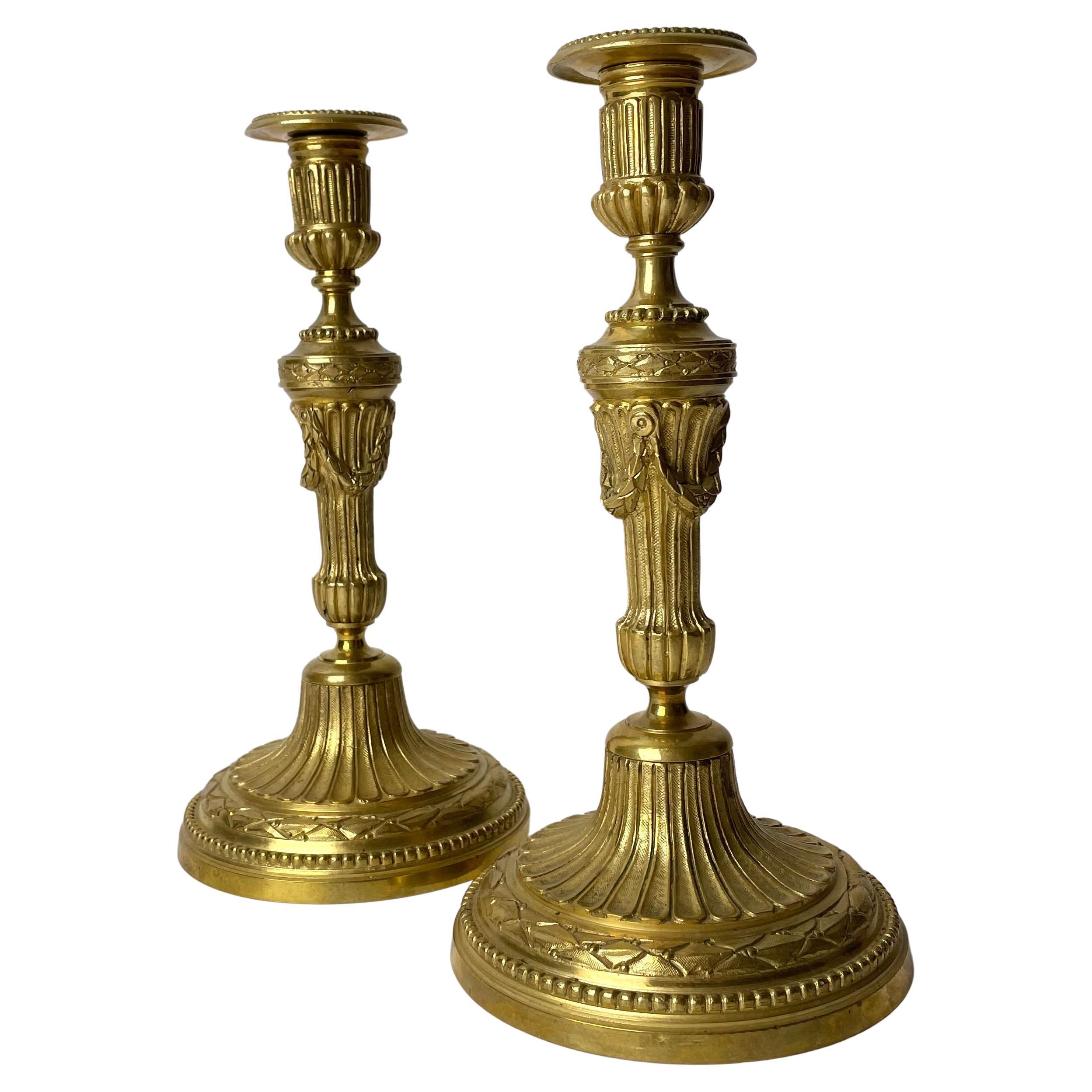 A Pair of Candlesticks in Gilt Bronze, 19th Century, in the style of Louis XVI For Sale