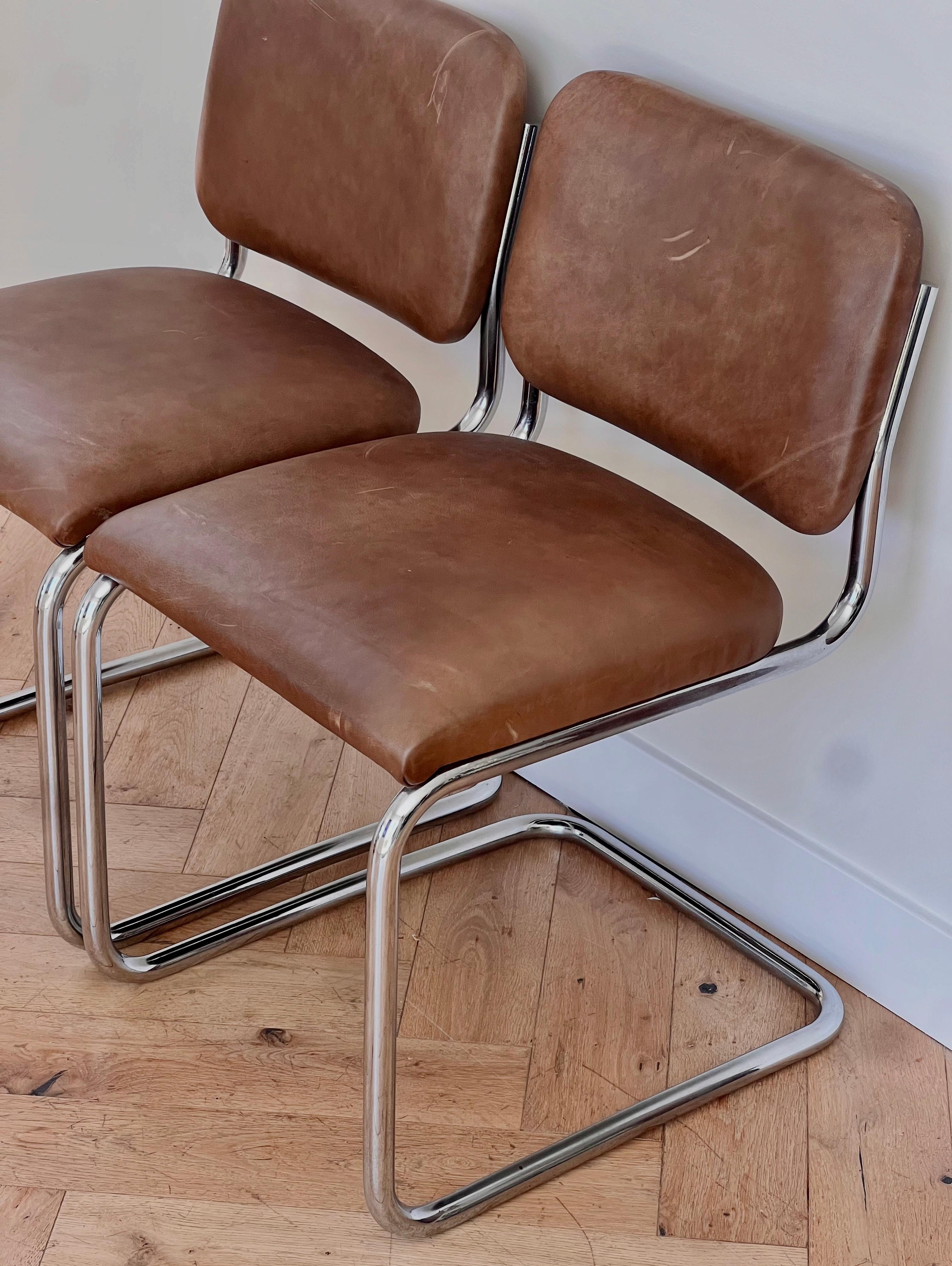 A pair of Bauhaus chrome and taupe leather or pleather cantilever chairs, probably mid 20th century.  If these are pleather, it’s very high quality fabric - genuinely can’t tell. Some wear to the upholstery but overall in great condition. Please