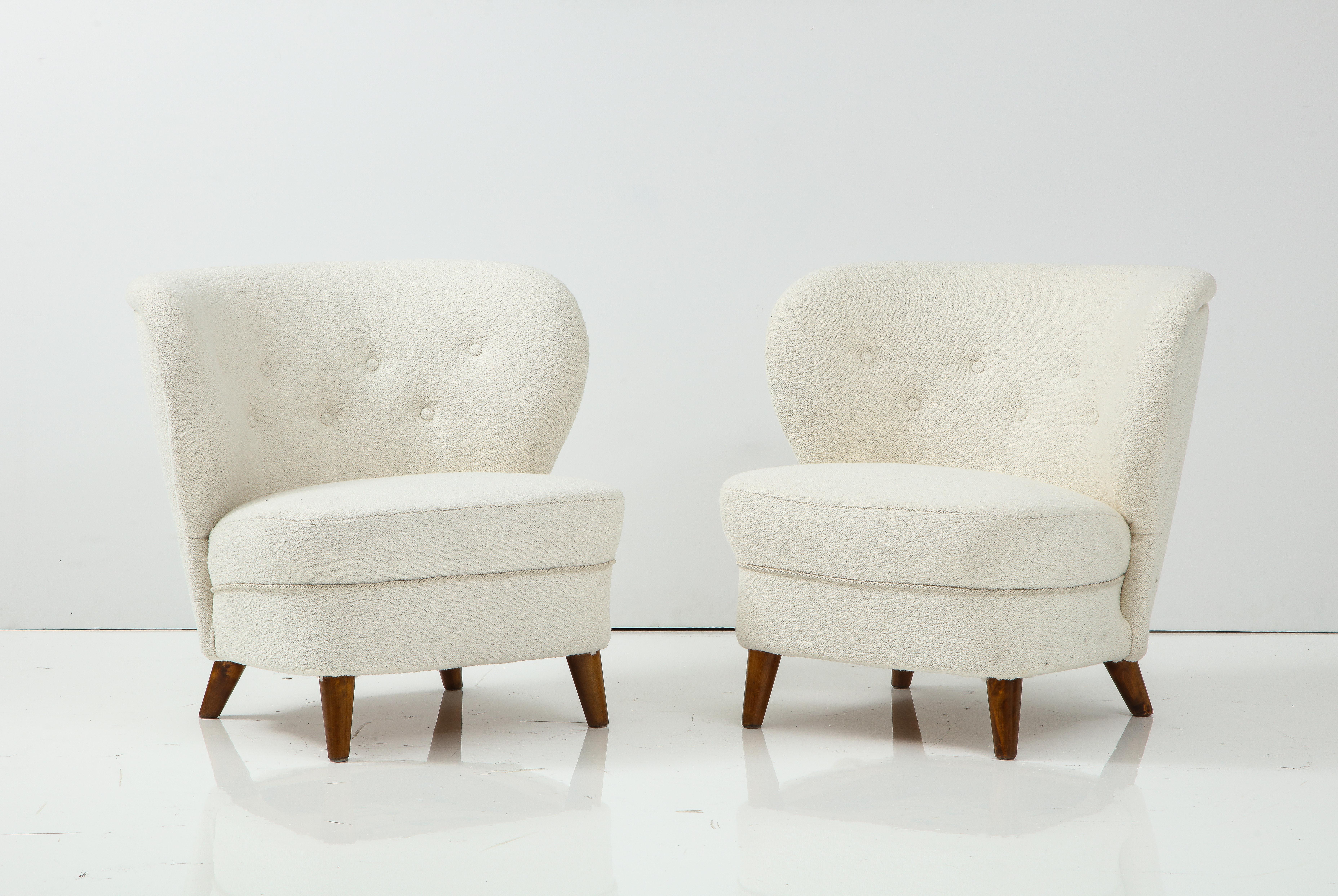 A pair of Carl-Johan Boman (Finnish 1883-1969) club chairs, Circa 1940s
Produced by Oy N. Boman AB, Turku, Finland. With generous curved backrests rand seats raised on stained beech legs. New off white wool bouclé upholstery
Boman was an educated