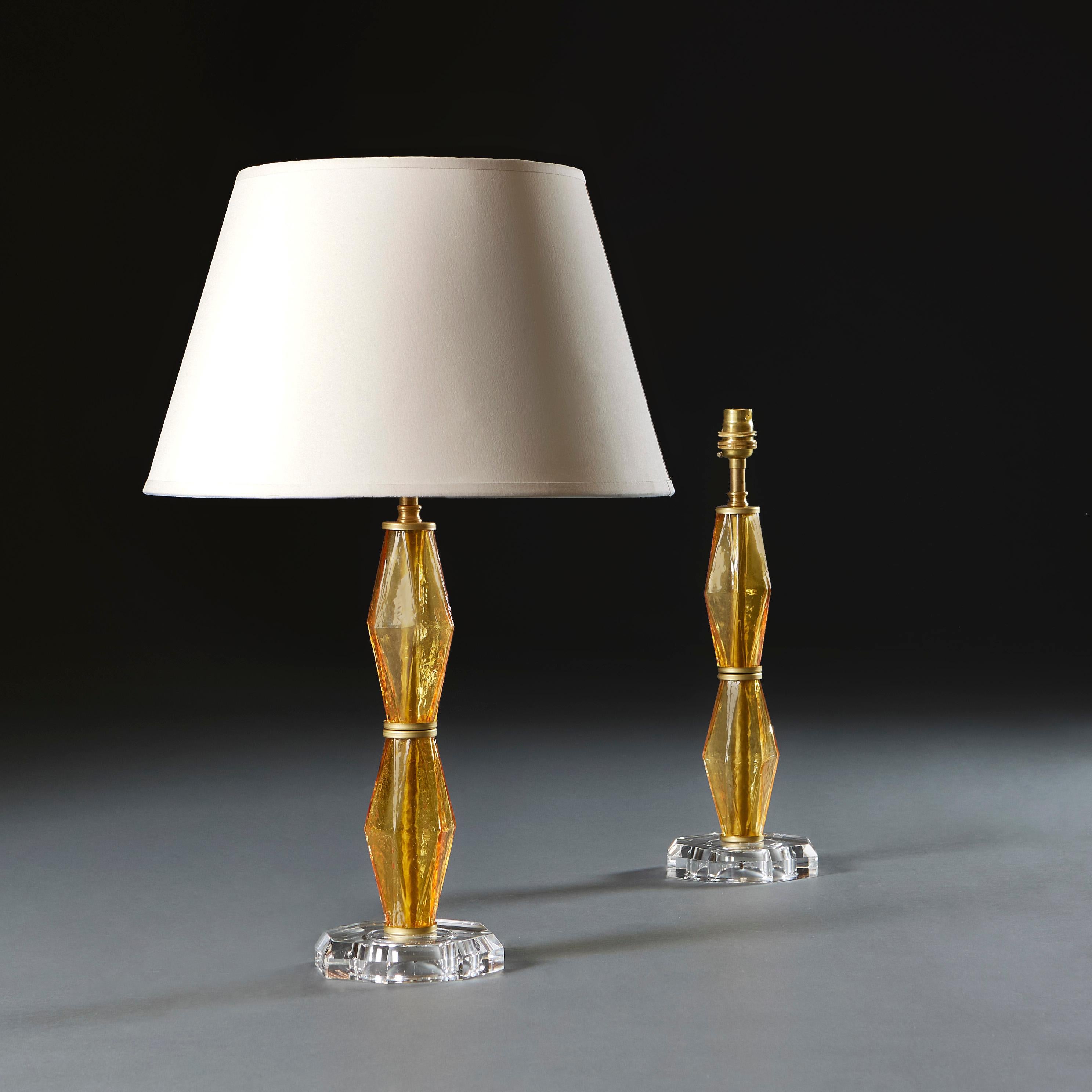 Italy, circa 1940

A pair of unusual amber glass lamps with diamond formation to the stem, supported on a clear glass octagonal base. After Carlo Scarpa.

Height 31.00cm
Height with shade 56.00cm
Diameter of base 12.00cm.

Please note: This is