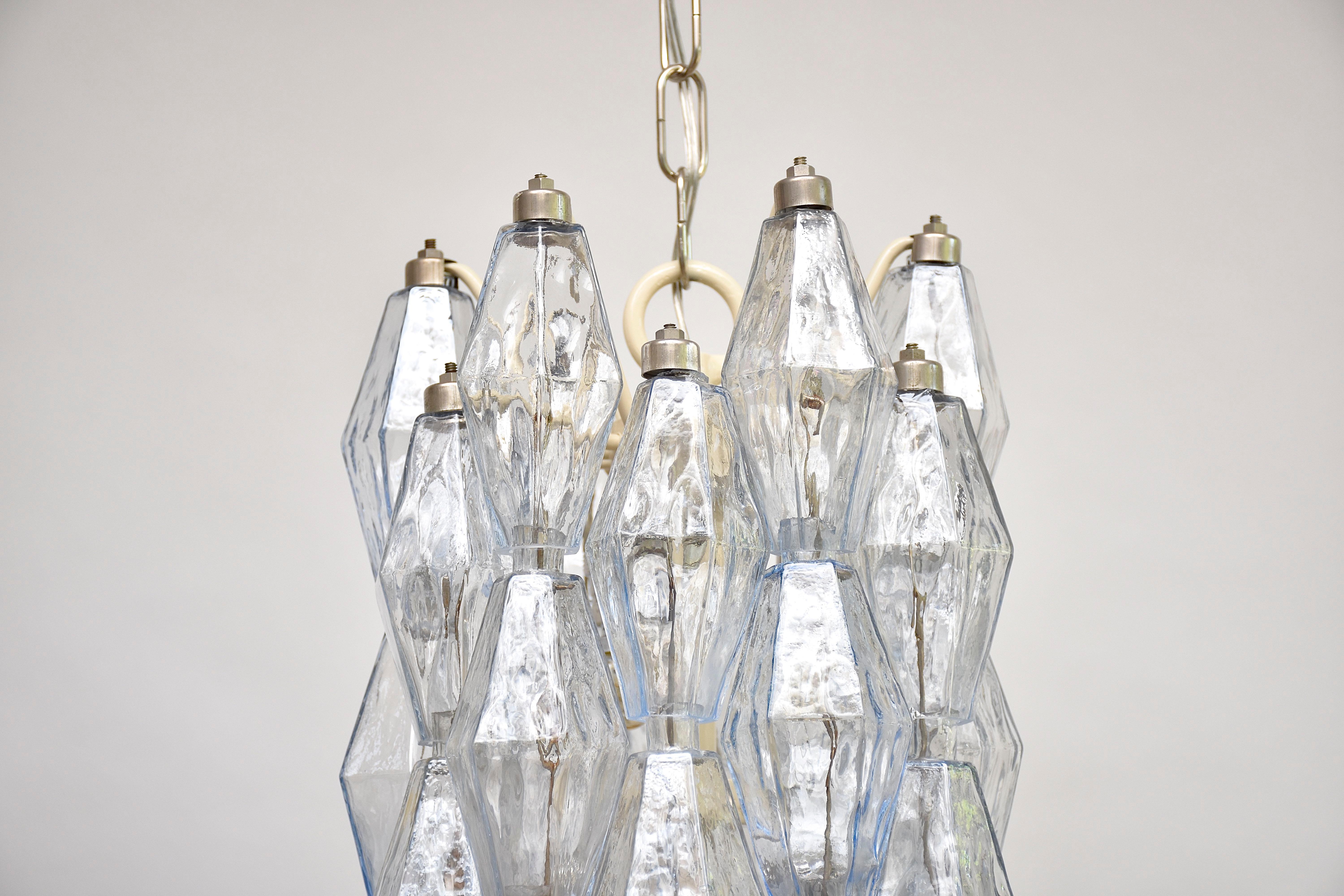 A very beautiful and original pair Murano chandeliers designed by Italian architect and designer Carlo Scarpa for Venini Murano.
Each with 9 lights.
Beautiful design where the advanced technique is visible.
With soft blue slightly iridescent moulded