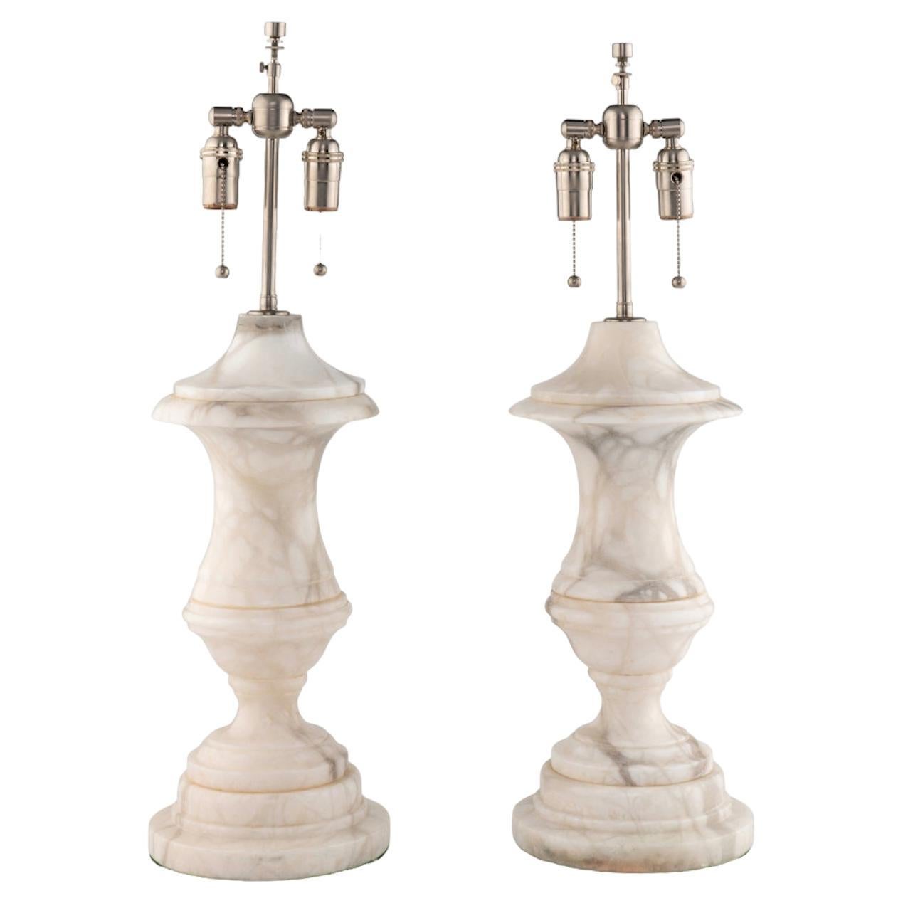 A Pair of Carrara Urn Lamps 20th Century from a David Easton-designed interior.