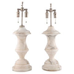 A Pair of Carrara Urn Lamps 20th Century from a David Easton-designed interior.